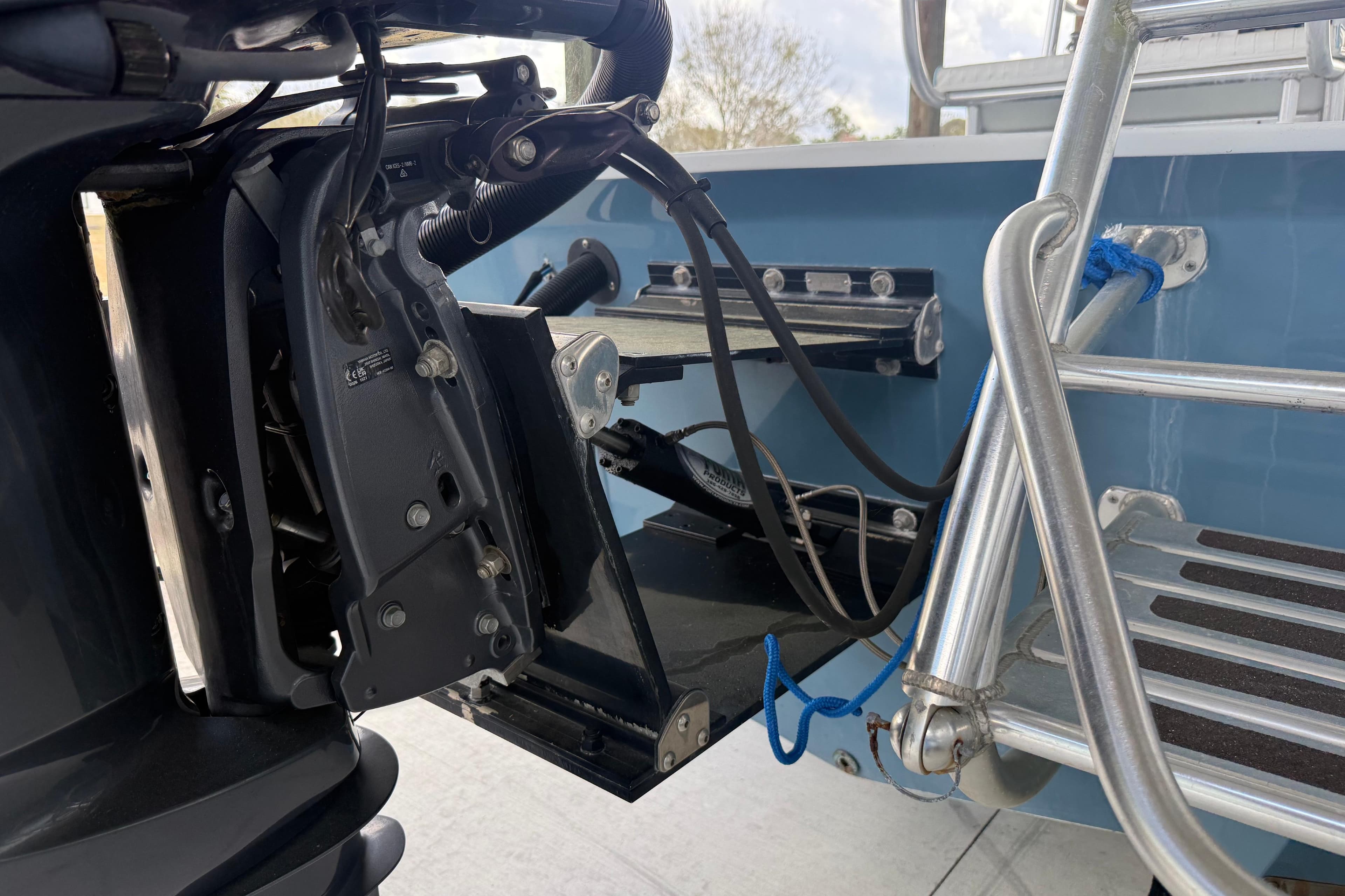 1974 Aquasport 2400 Center Console boat engine and ladder detail.