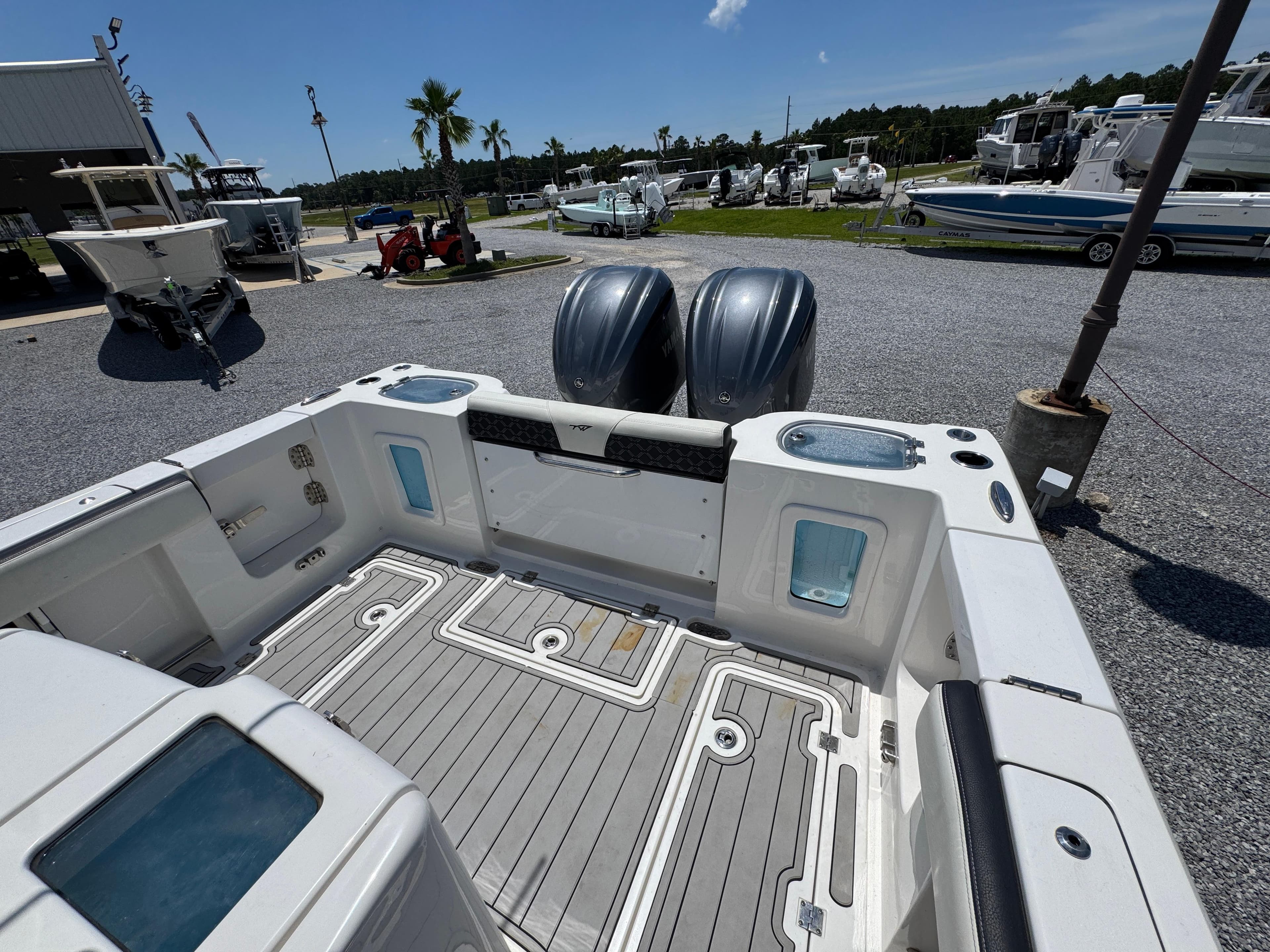2023 Tidewater 282 CC Adventure Bluewater boat interior with dual engines, docked outdoors.