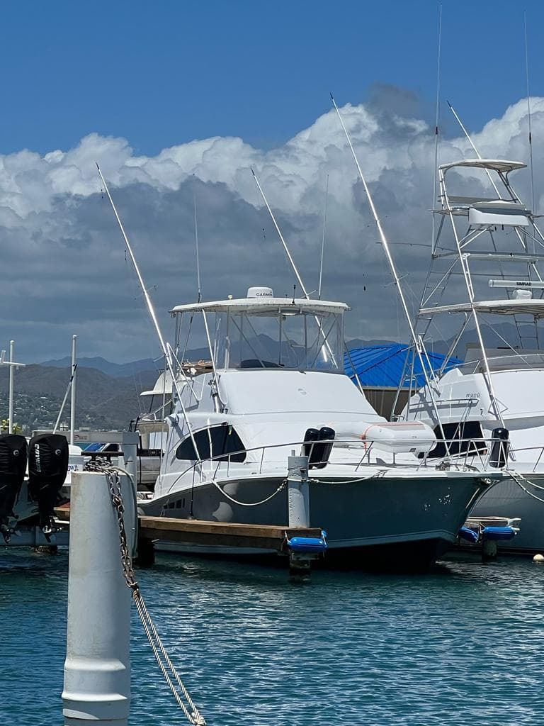 1994 Luhrs 380 Tournament yacht docked at marina under clear blue sky.