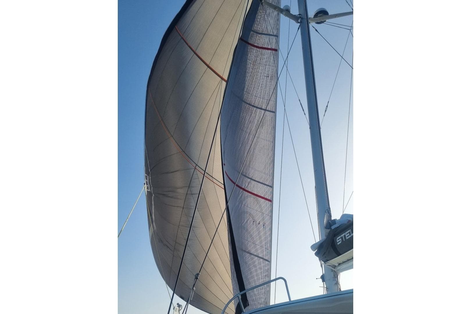 Sailing yacht Ice Cat 61, 2017 model, with sails unfurled against a clear sky.