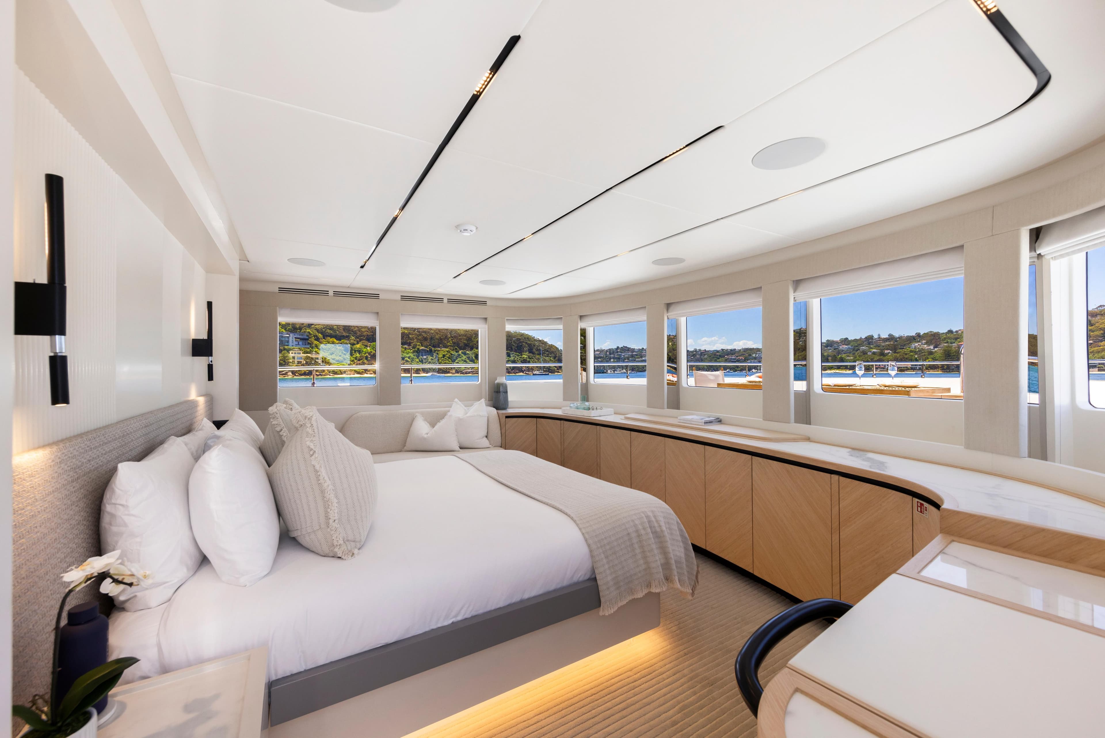 Luxurious interior of 2023 Gulf Craft Nomad 101 yacht with panoramic windows and elegant furnishings.