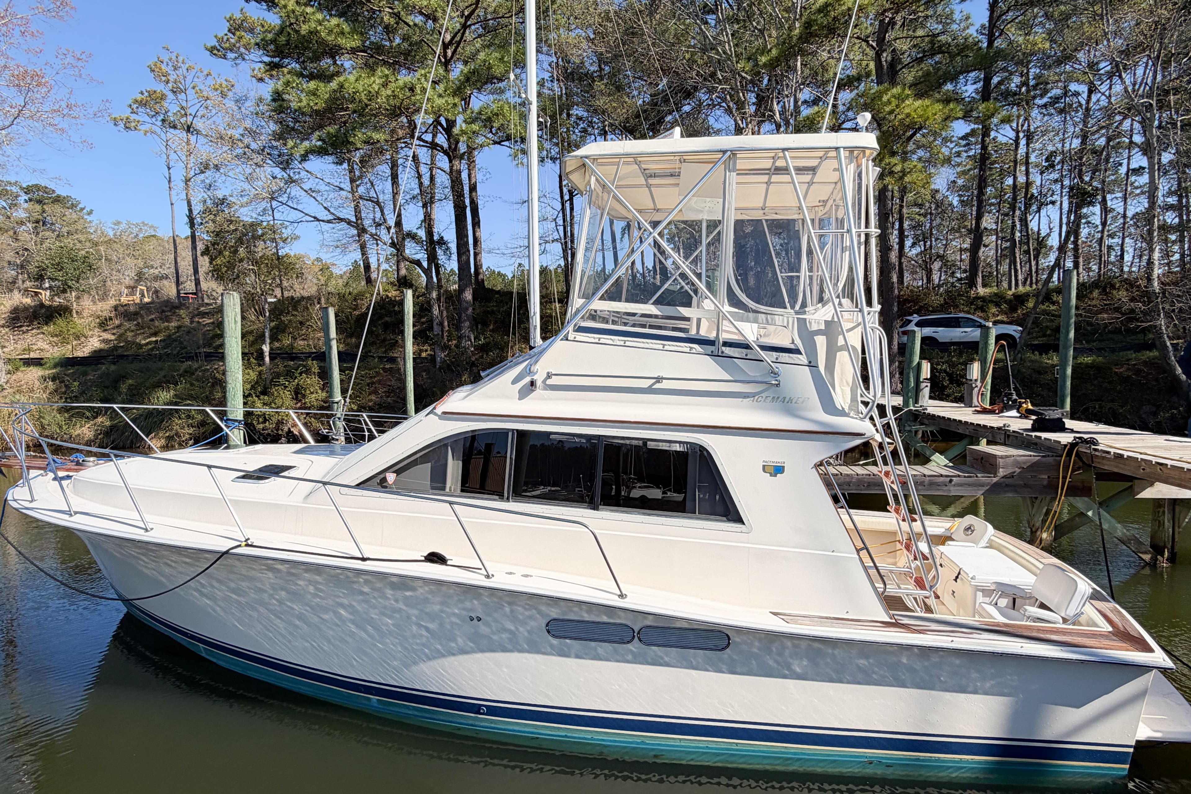 1988 Pacemaker 36 Convertible yacht docked in a serene marina setting.