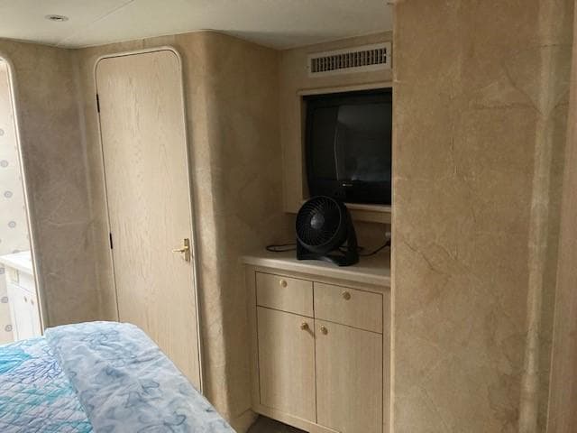 Interior cabin of a 1998 Ocean Yachts 45 Super Sport with TV and fan.