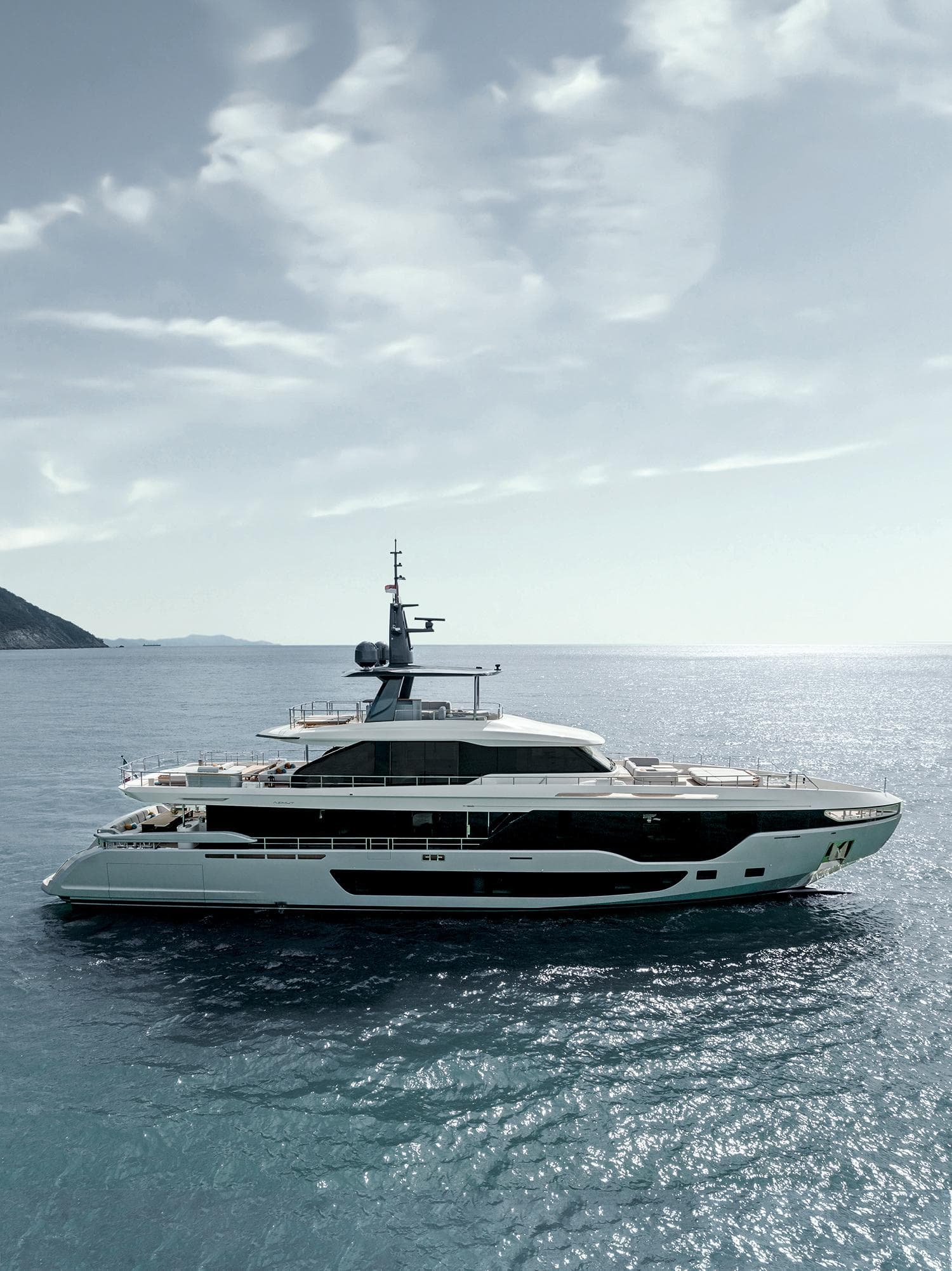 2024 Azimut Grande 36M luxury yacht cruising on open sea under a cloudy sky.