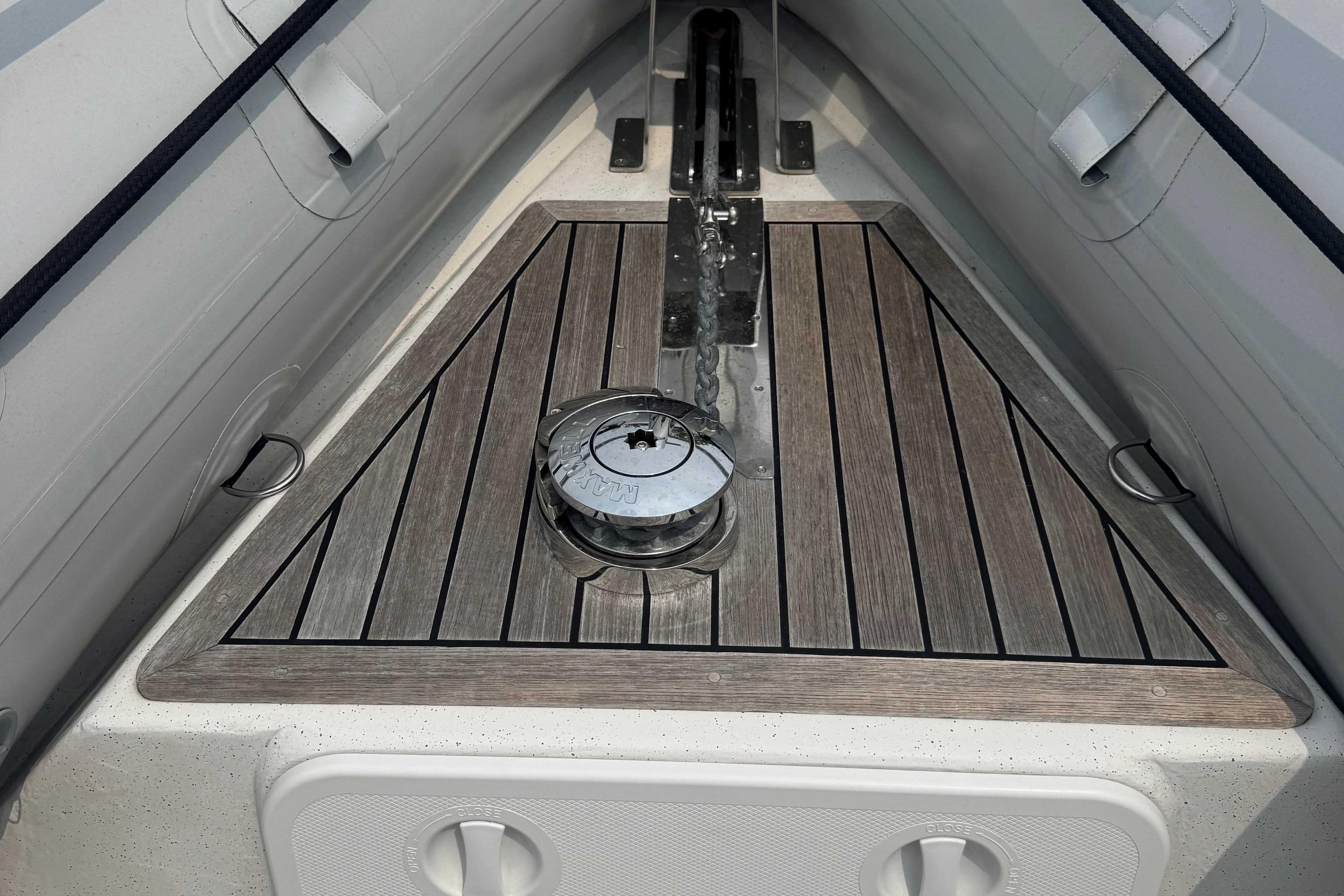 2016 Protector 30 Center Console boat deck with wood finish and anchor chain.