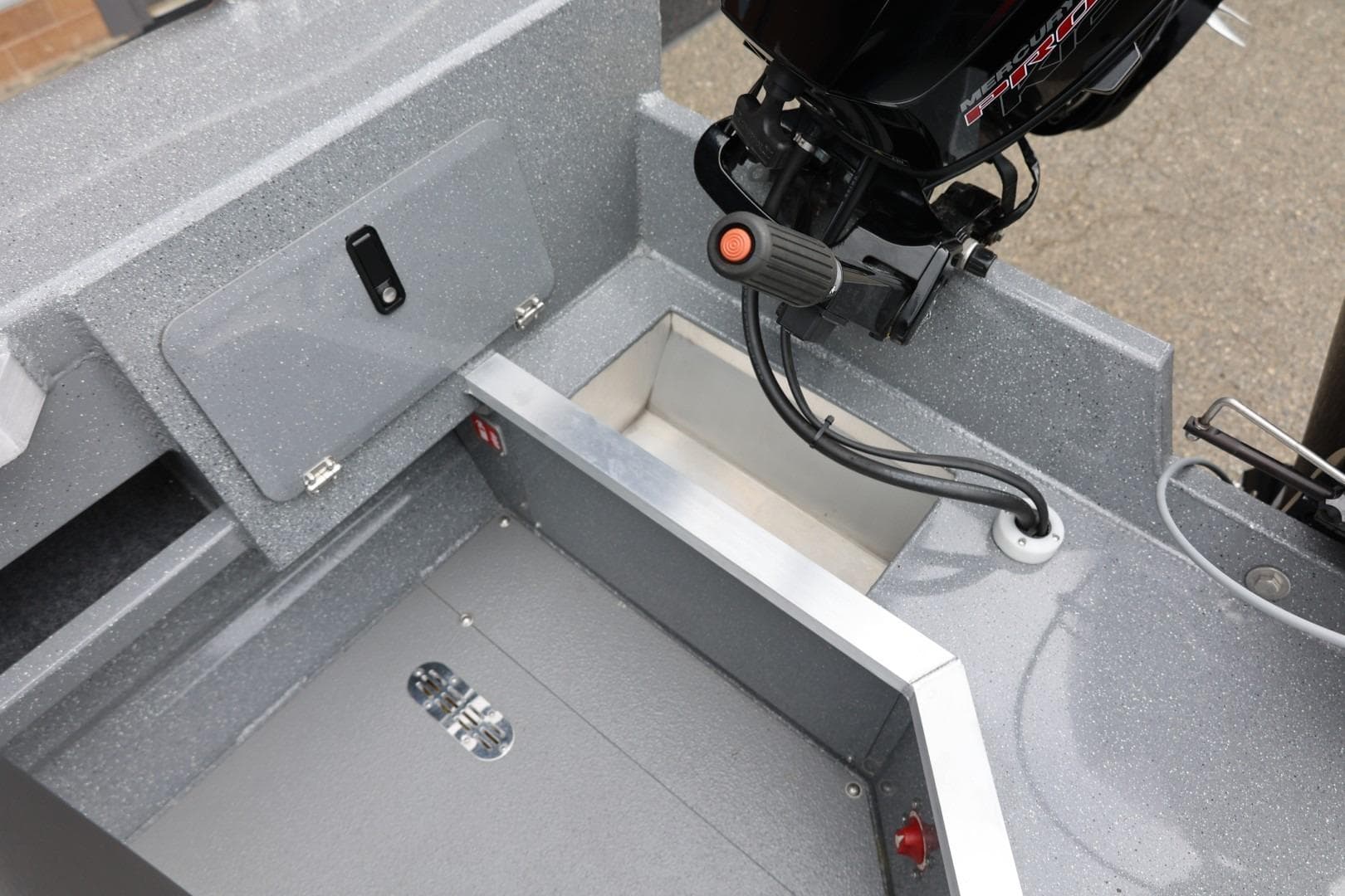 Interior view of 2025 Thunder Jet 209 Rush OT boat, showcasing storage and motor area.