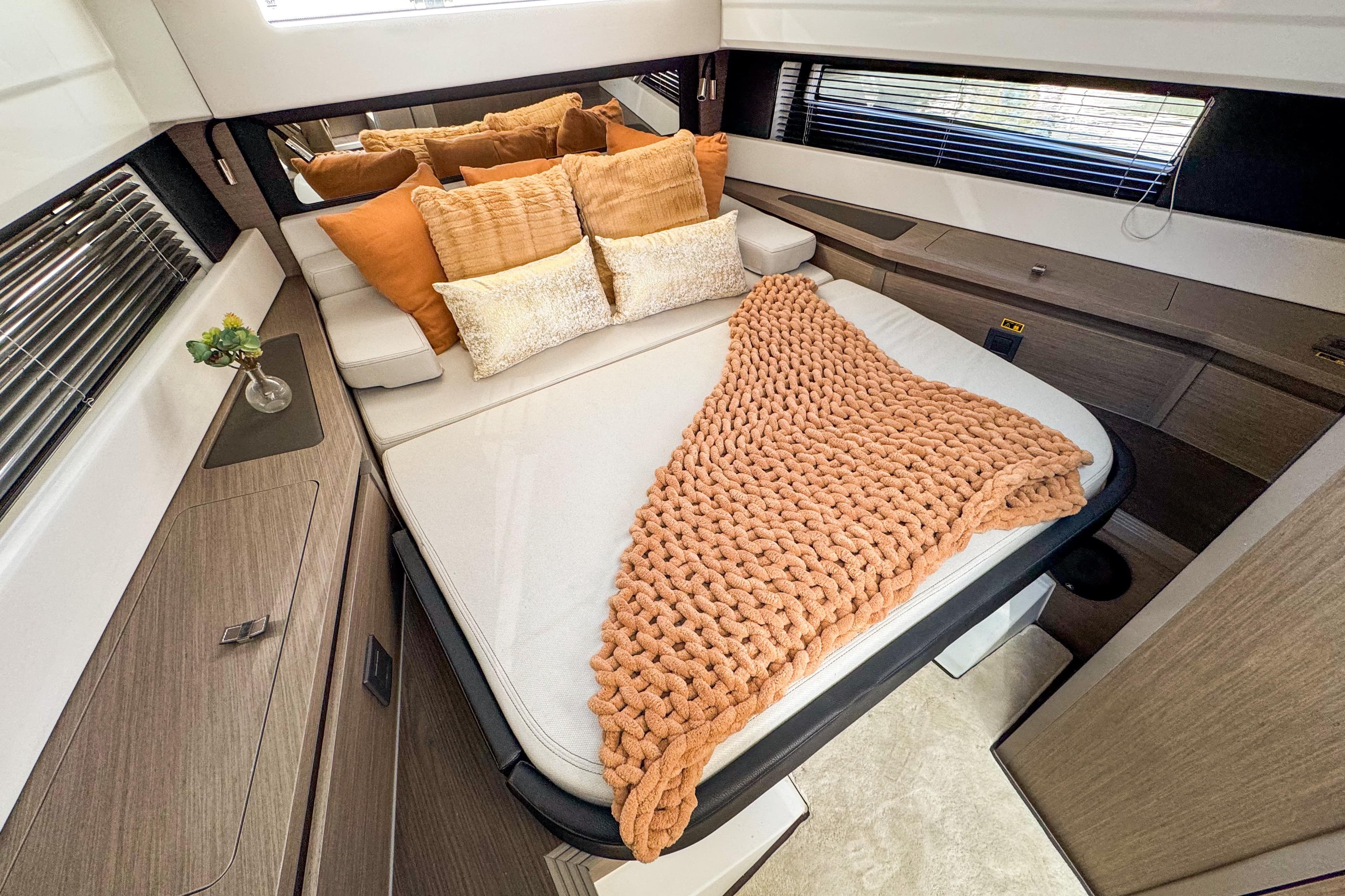 Luxurious cabin interior of 2025 Wellcraft 38 Explorer with cozy bedding and modern decor.