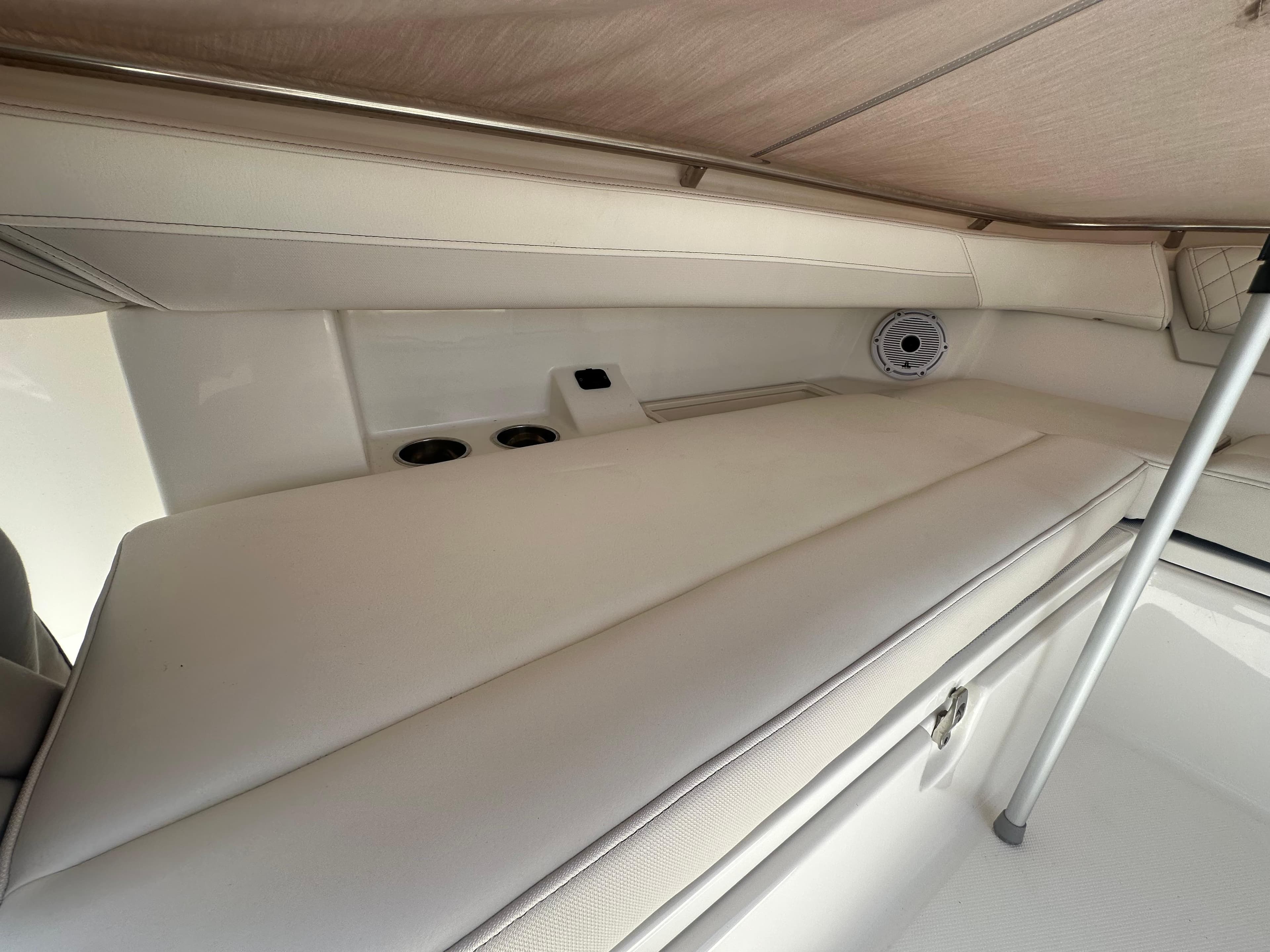 2024 World Cat 280ccx interior cabin with cushioned seating and speaker system.