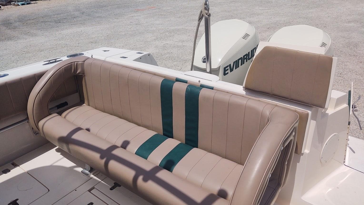 2005 Intrepid 310 Walkaround boat seating with Evinrude engines in the background.