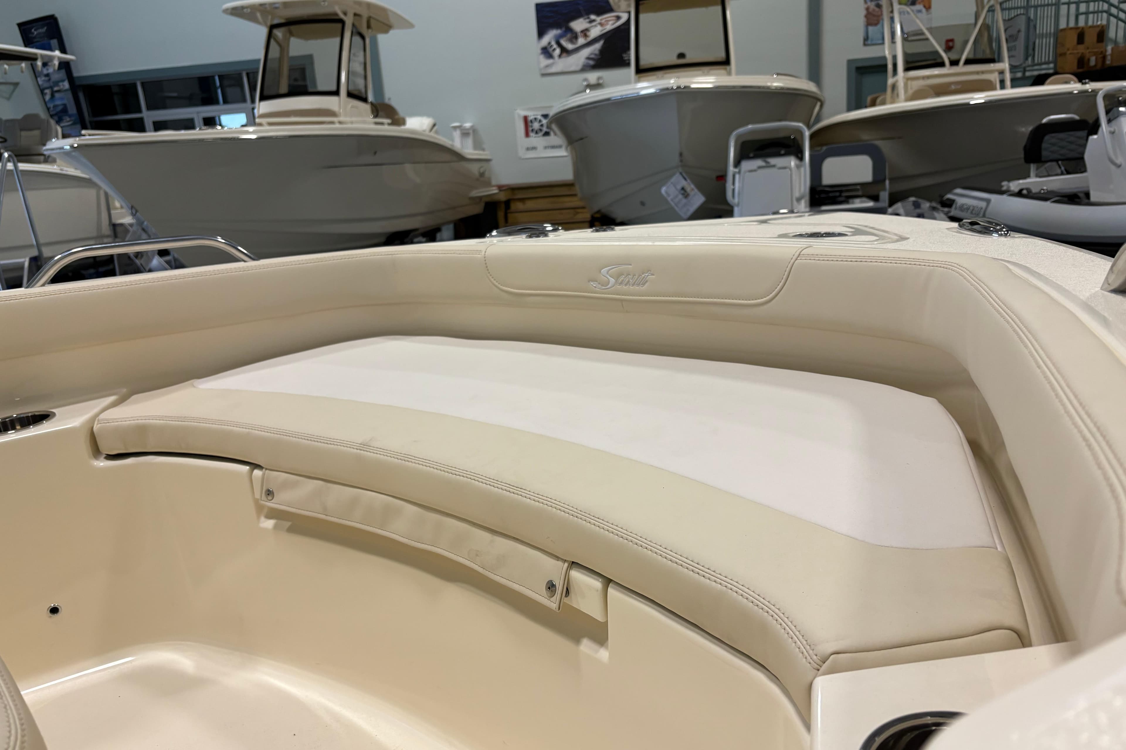 2026 Scout 188 Sportfish boat interior with beige seating in showroom.