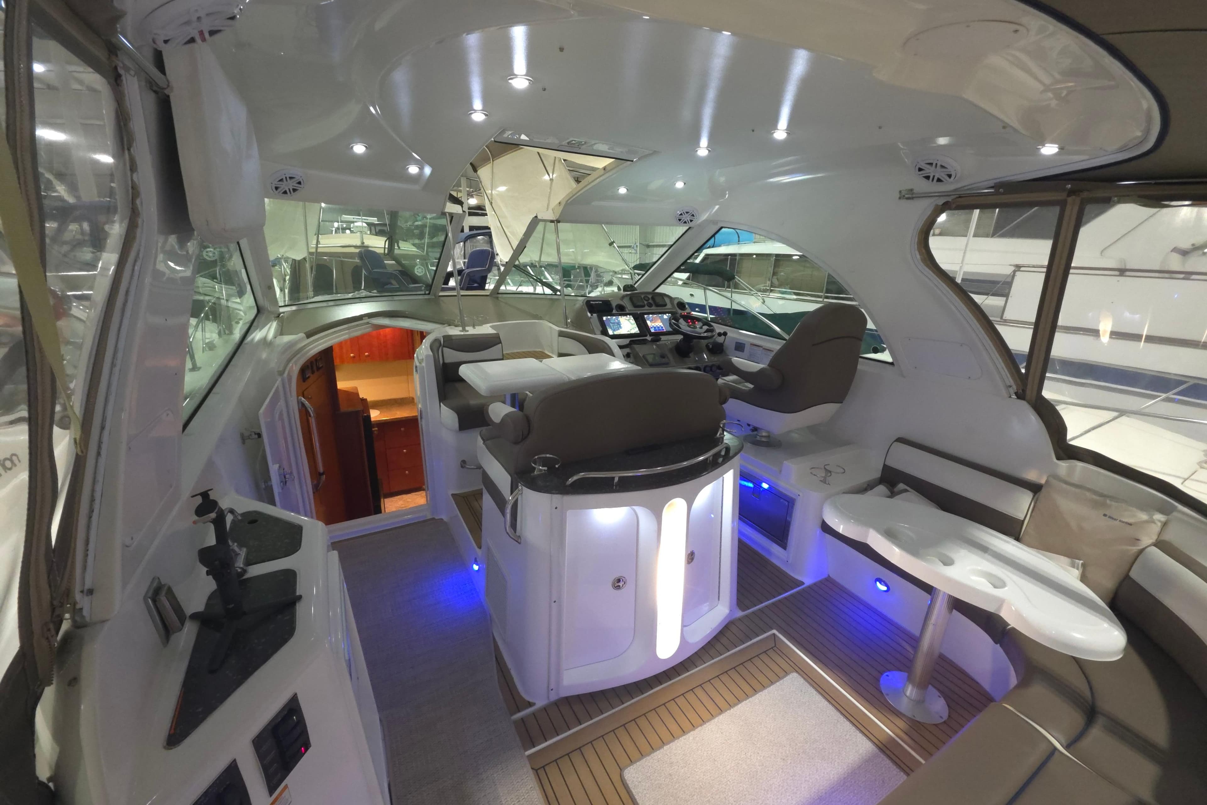 Luxurious interior of 2008 Cruisers Yachts 390 Sports Coupe with modern seating and navigation area.