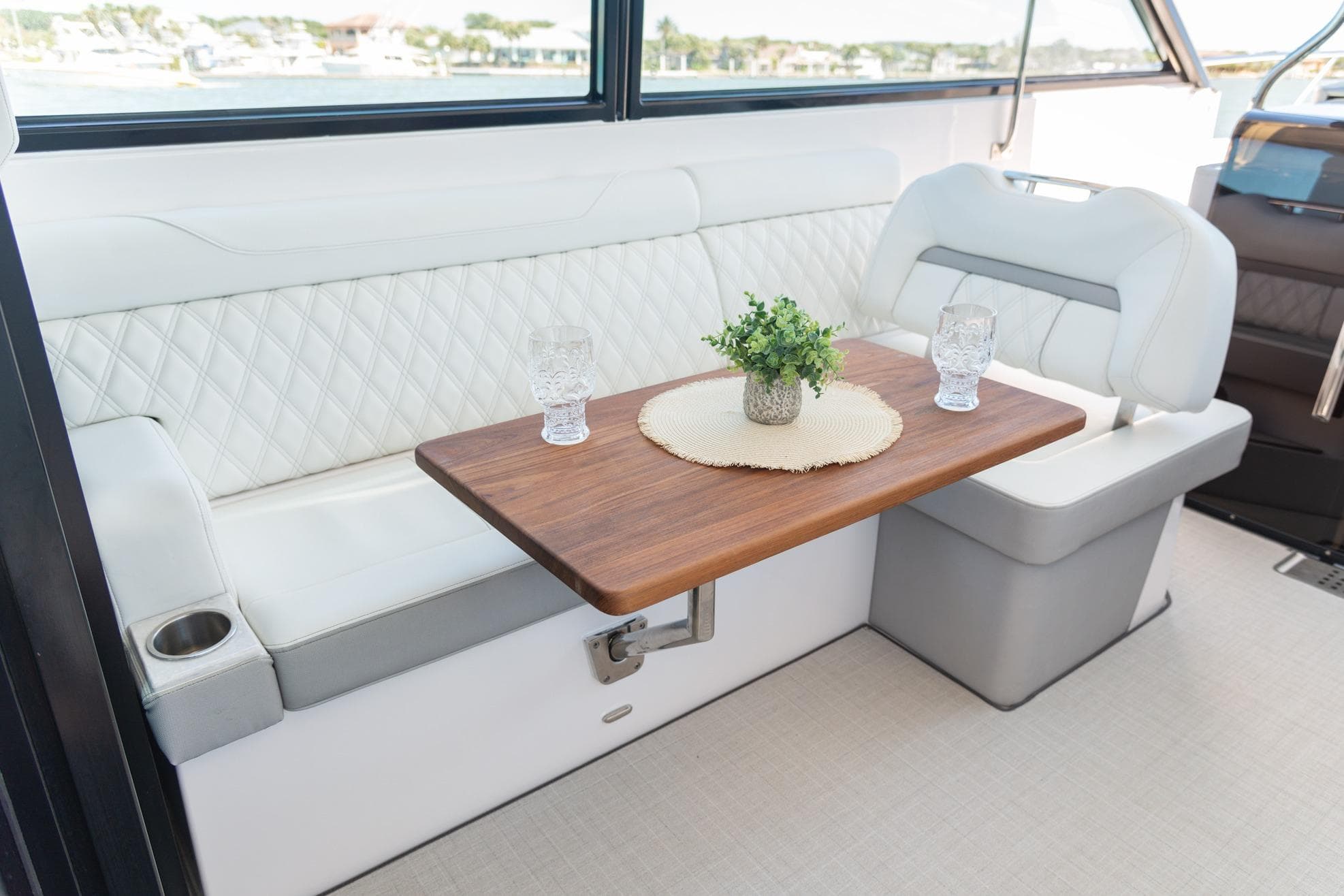 Luxurious interior of 2026 Regal 36 XO yacht with elegant seating and wooden table.