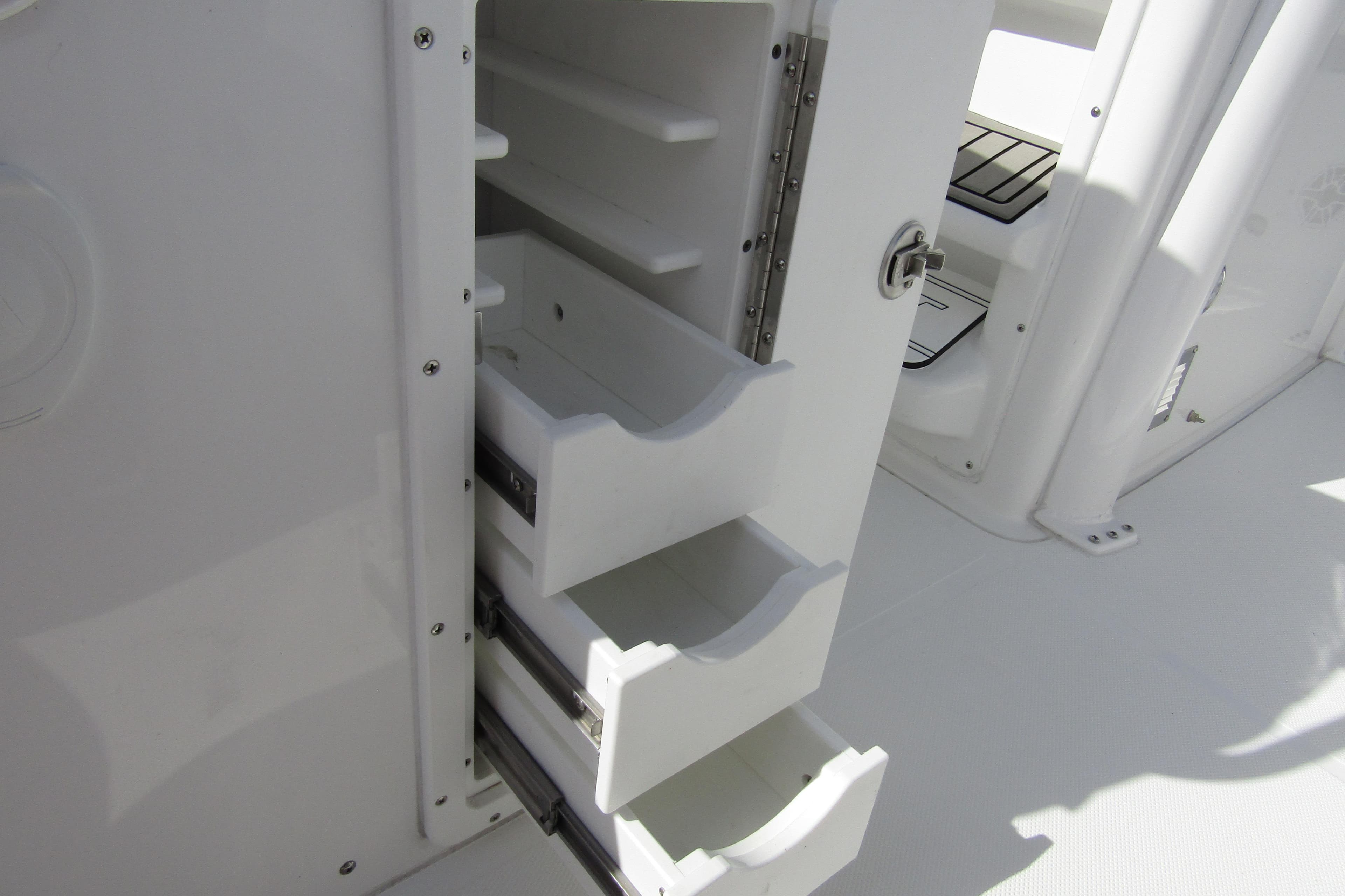 Open storage drawers on a 2025 Sea Hunt Ultra 275 SE boat.