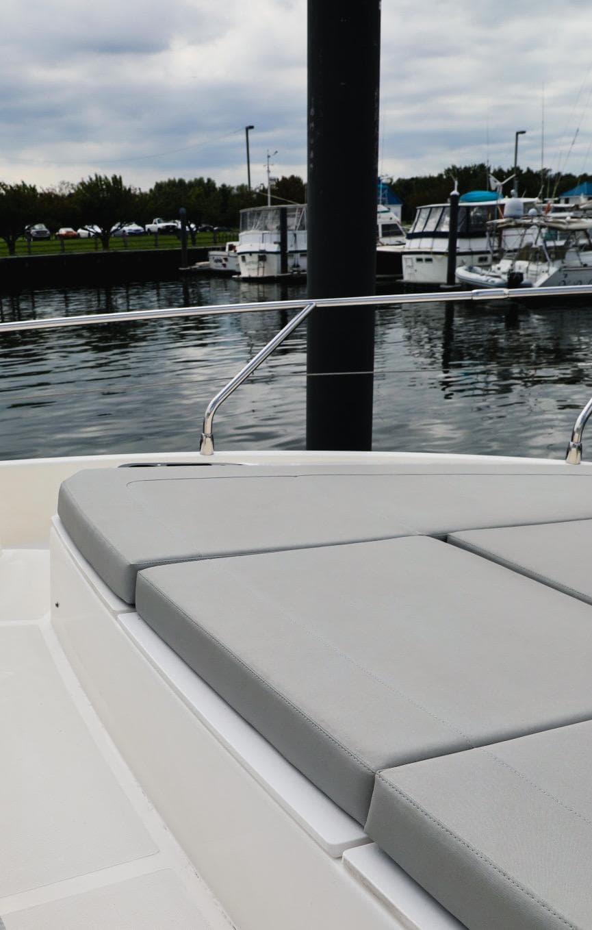 2019 Absolute 50 Fly yacht with cushioned deck, docked in a marina.