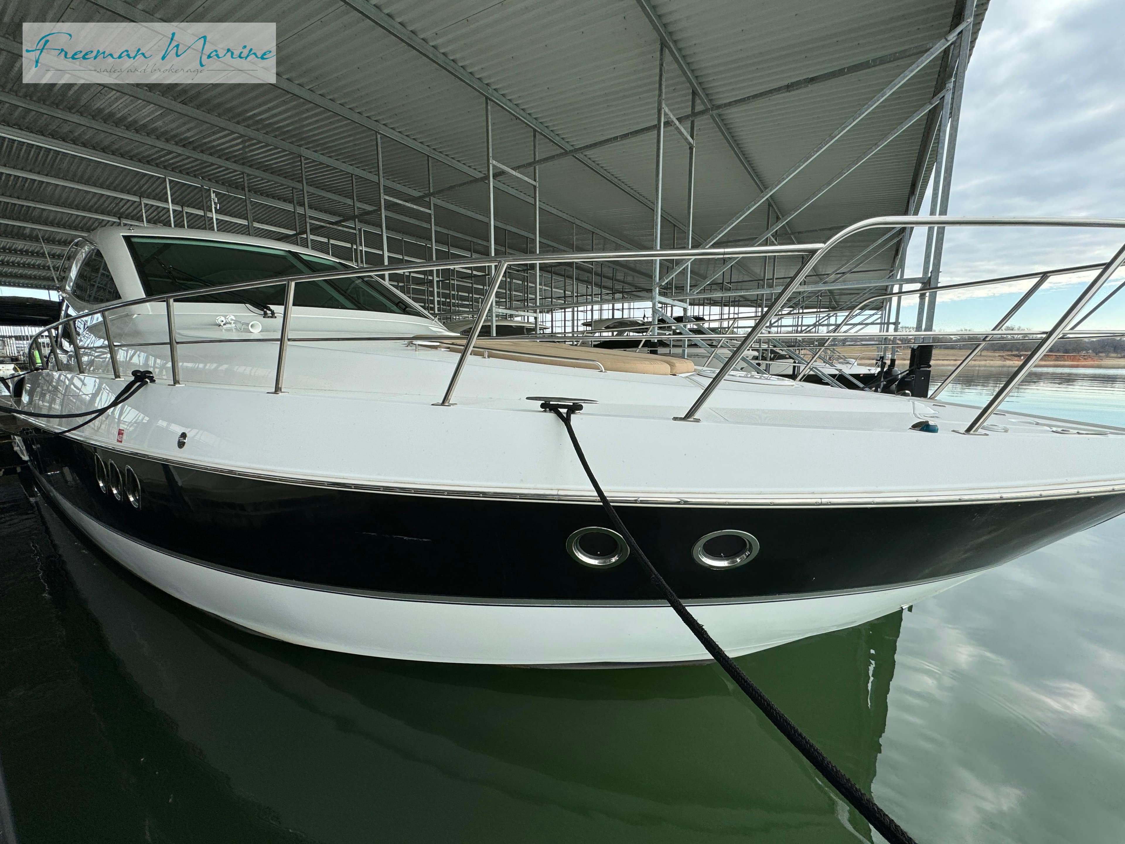 2014 Cruisers Yachts 540 Sports Coupe docked in a covered marina.
