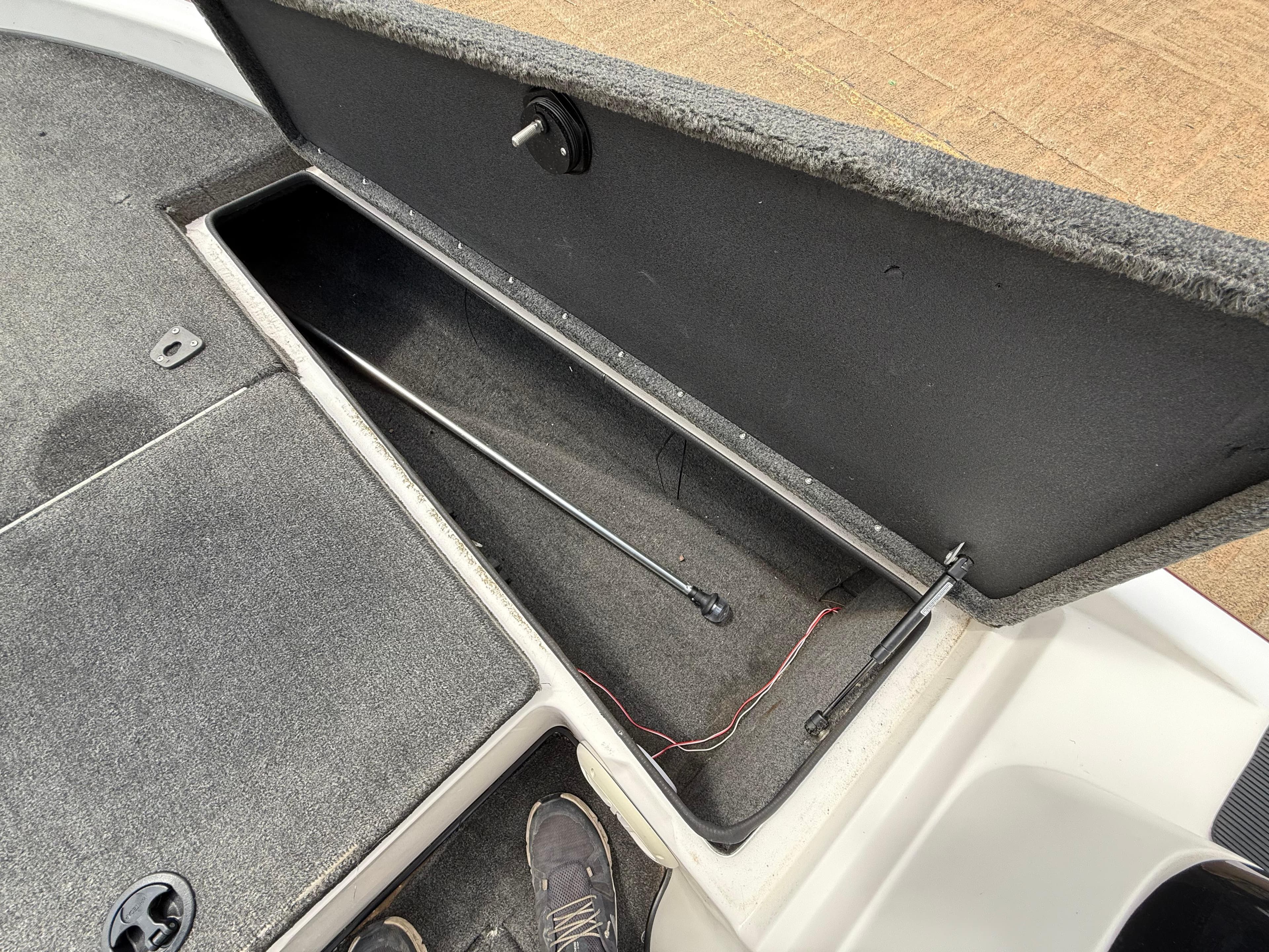 Open storage compartment of a 2003 Skeeter SX190 boat.