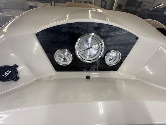 Dashboard of 2017 Harris Cruiser 200 boat with gauges and USB port.