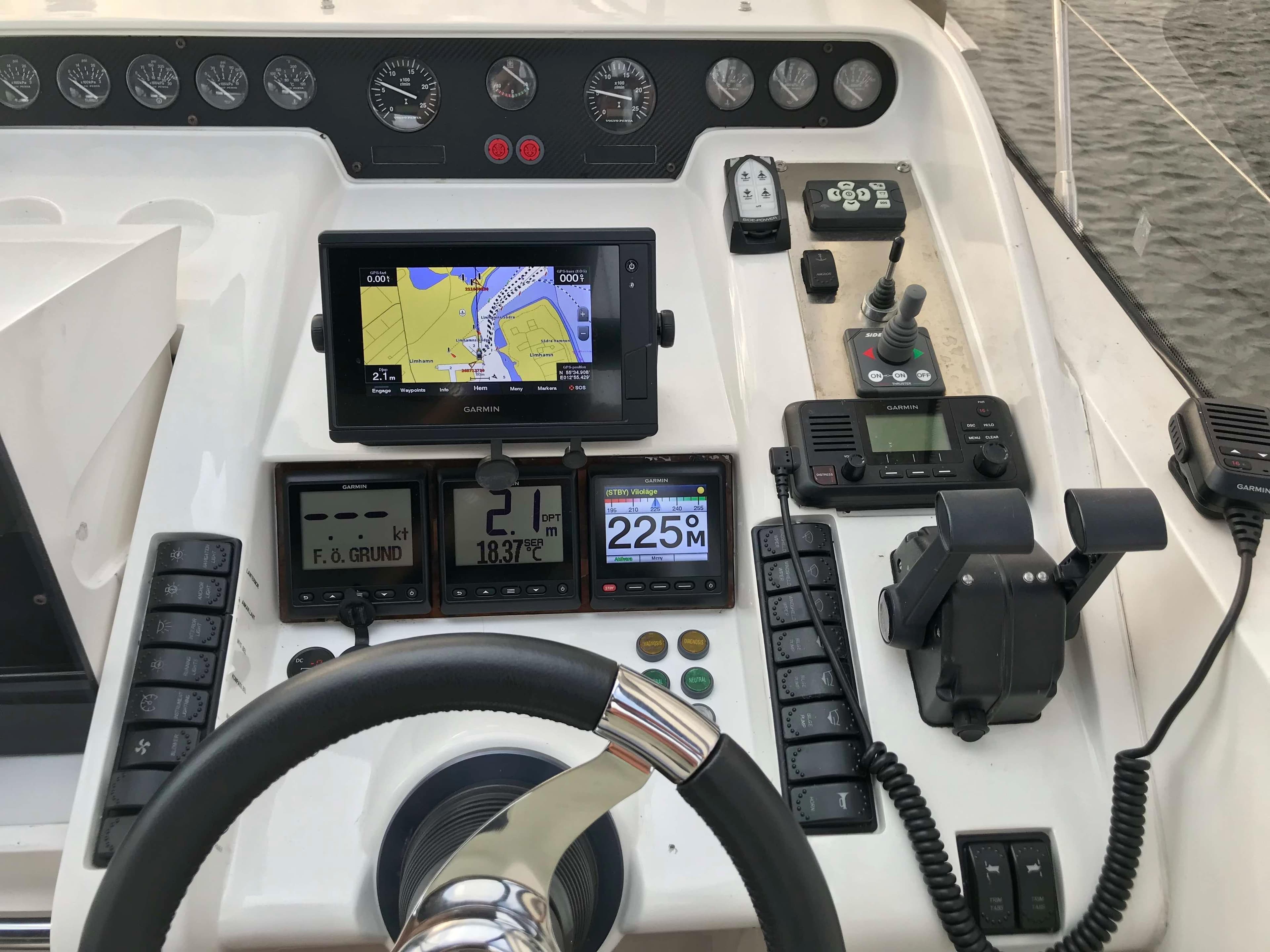 Control panel of a 1998 Princess V55 yacht with navigation and communication equipment.