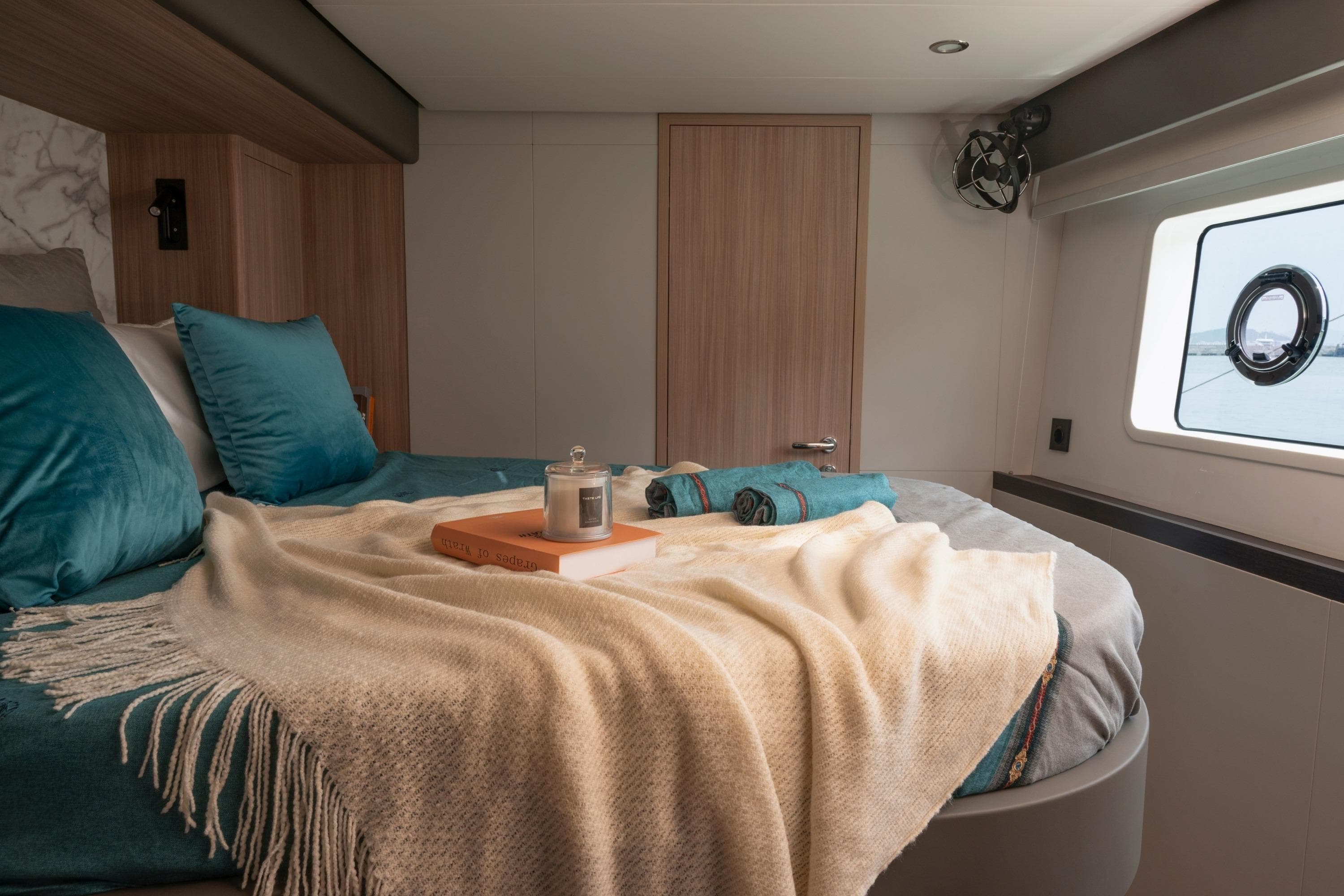 Luxurious bedroom interior of 2026 Heysea SV60 yacht with cozy bedding and window view.