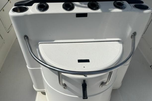 2007 Triton 2895 CC boat console with rod holders and stainless steel railing.