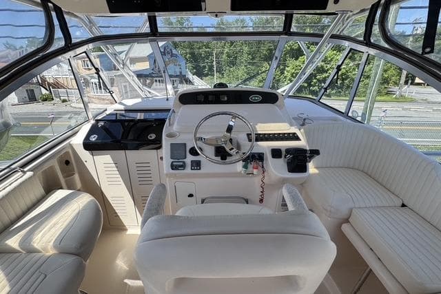 2008 Grady White 330 Express boat cockpit with steering wheel and seating area.