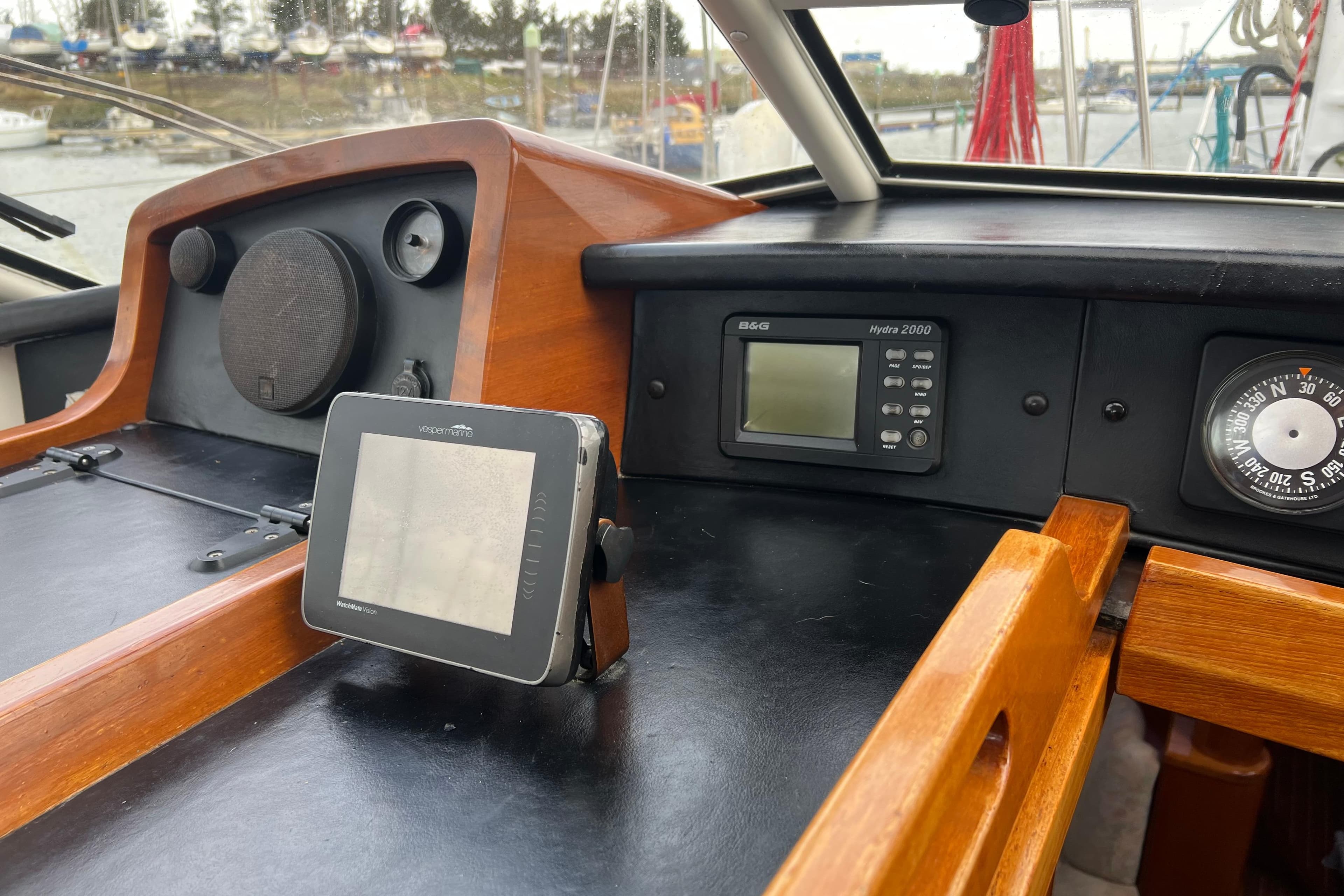 Cockpit of 1990 Trintella 49A yacht with navigation instruments and wooden finish.