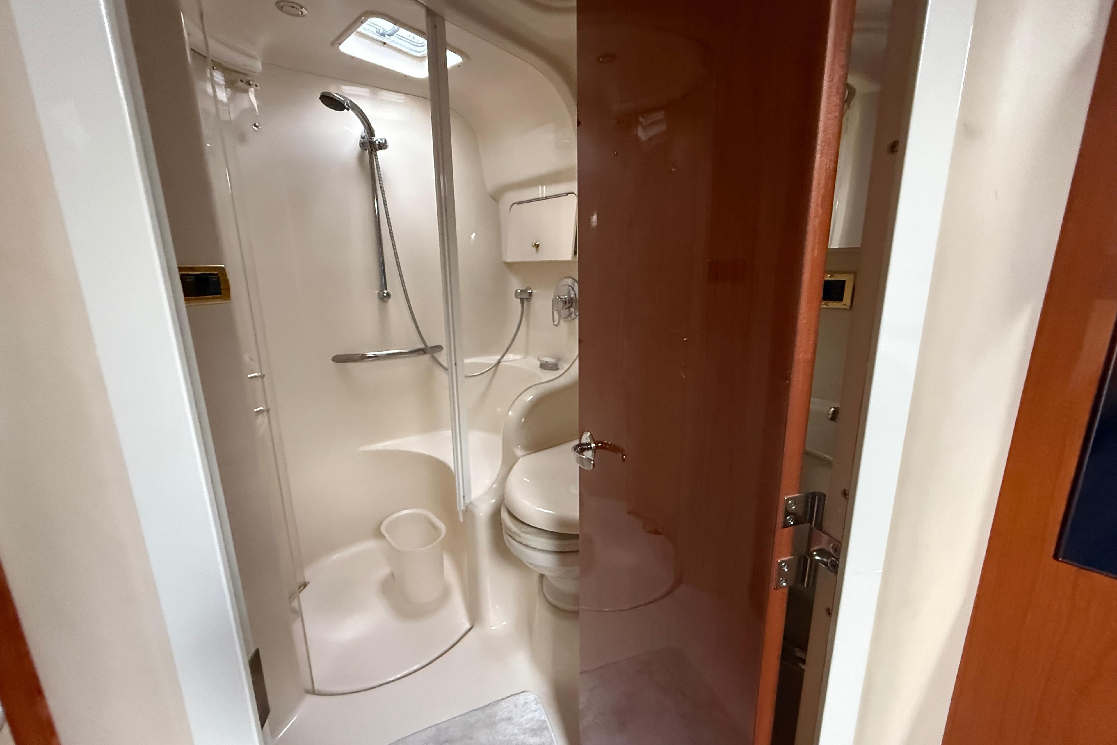 Bathroom interior of 2001 Sea Ray 410 Sundancer yacht, featuring shower and toilet.