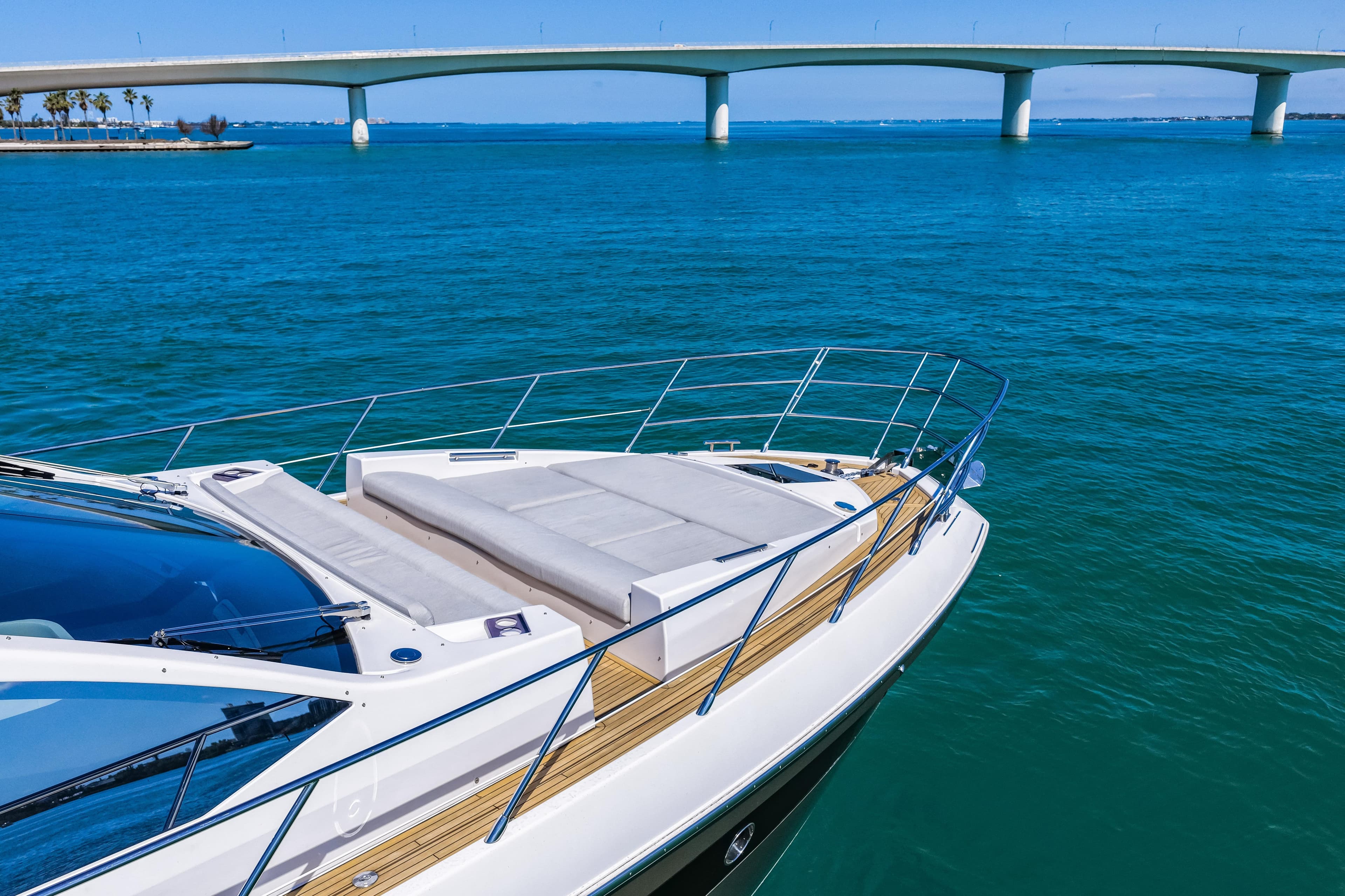 2020 Azimut S6 yacht on blue water near a bridge, showcasing luxury design.