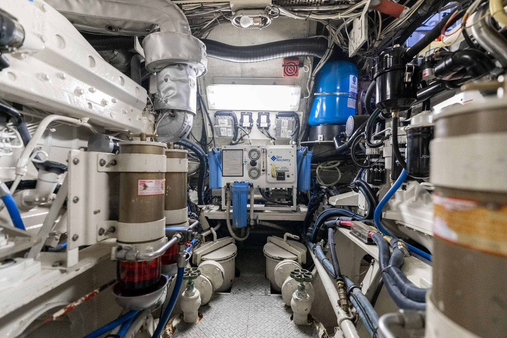 Engine room of a 1965 De Vries Lentsch 64 Motoryacht, showcasing mechanical components.