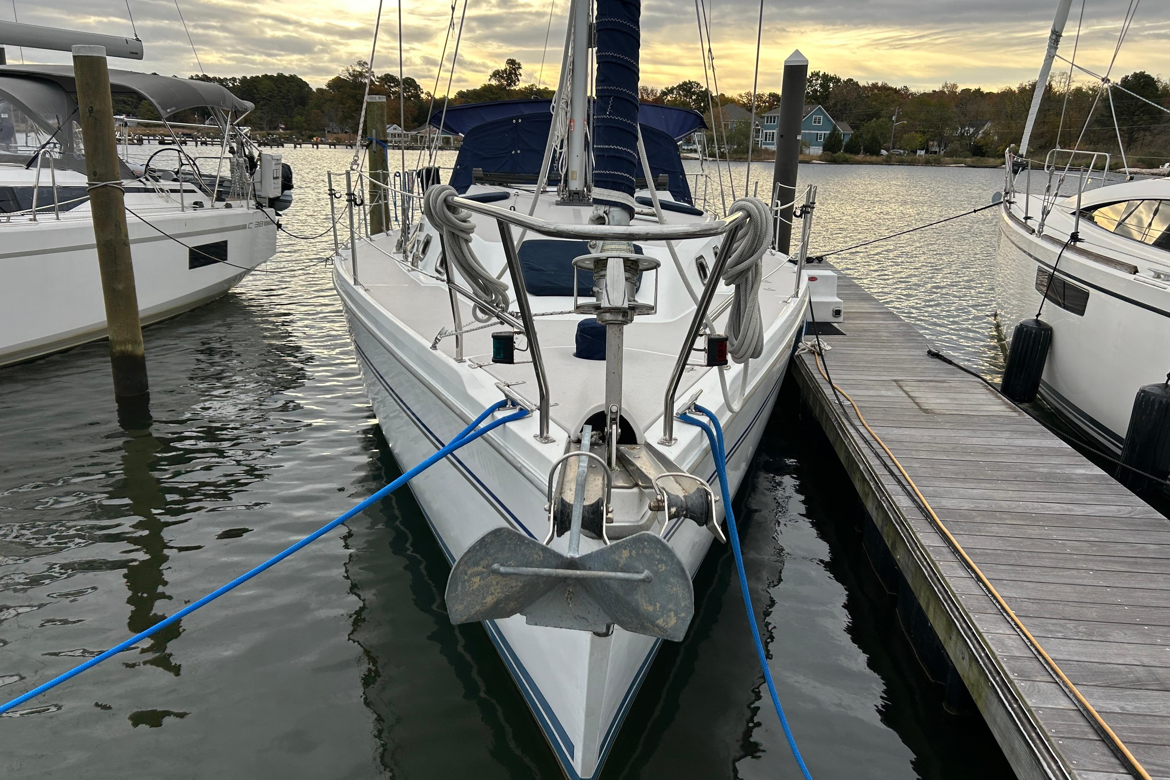 2009 Catalina 375 sailboat docked at marina, front view, calm water, overcast sky.