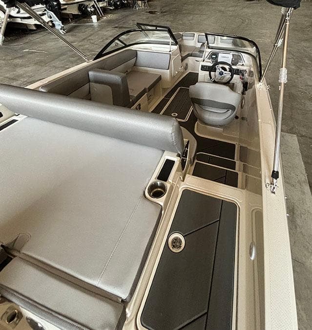 2024 Bayliner DX2000 boat interior with seating and steering console.