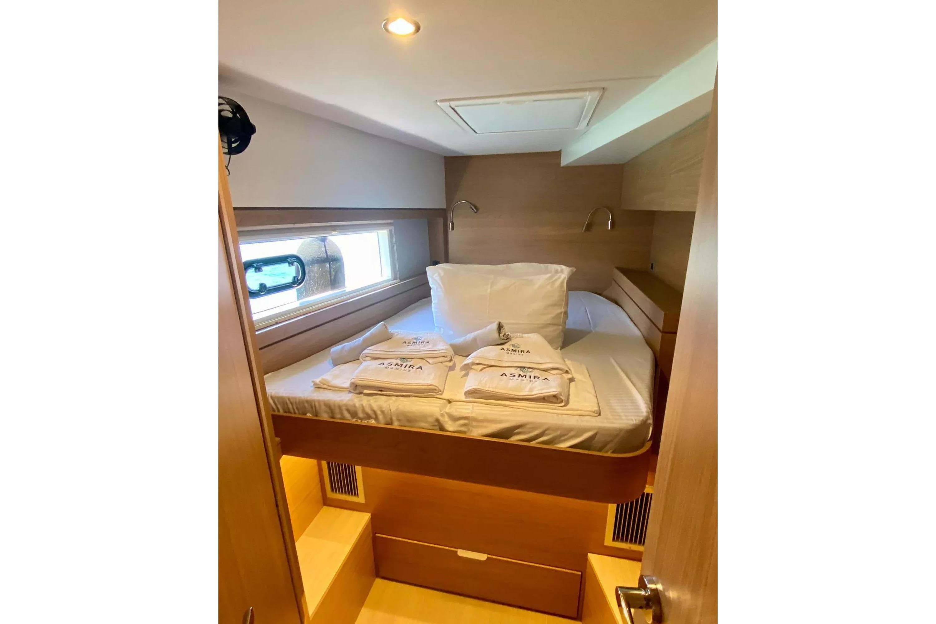 Cozy cabin interior of 2024 Bali 4.4 yacht with bed and window view.
