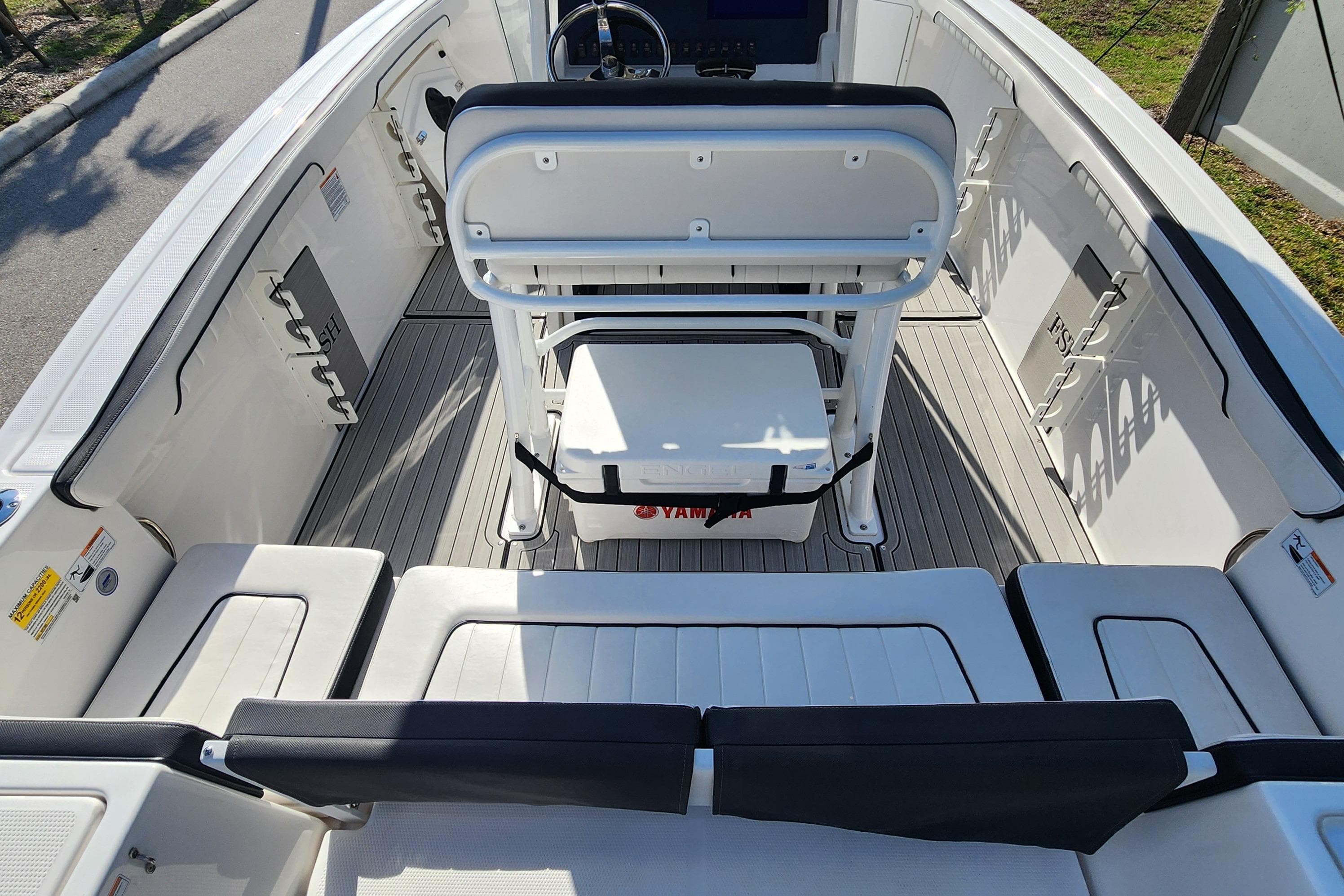 2022 Yamaha 255 FSH Sport E boat interior with seating and steering console.