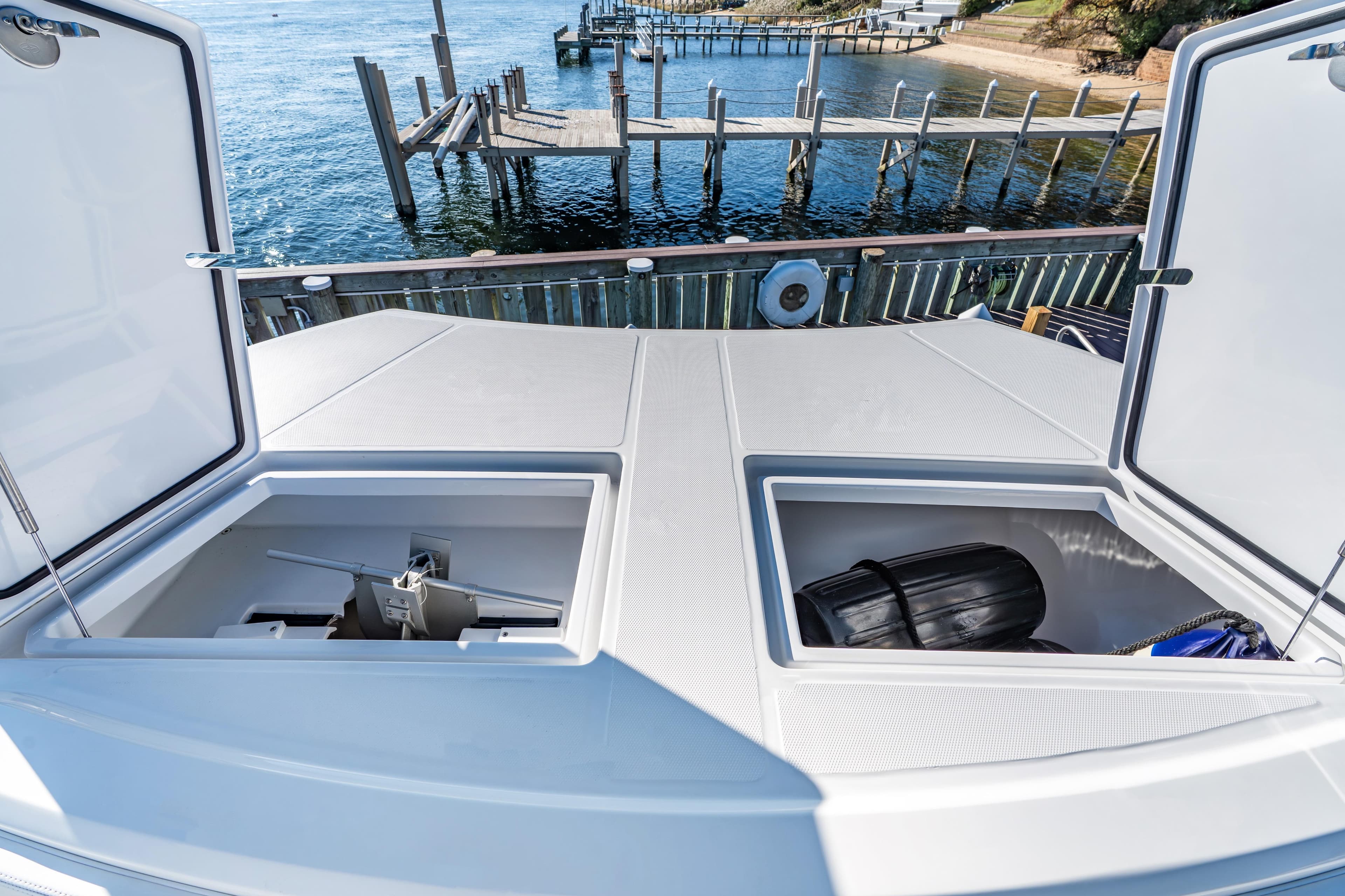 Open storage compartments on 2025 Front Runner 43 Catamaran, dockside view.
