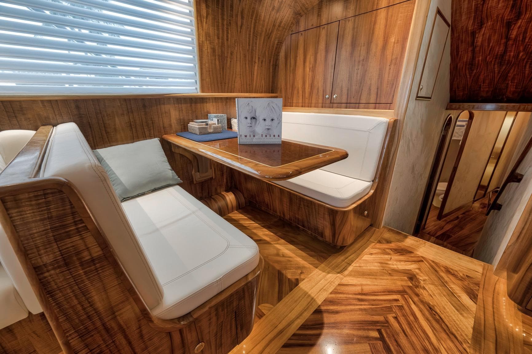Luxurious 1999 Hines-Farley SPORTFISHERMAN yacht interior with elegant wood finish and cozy seating.