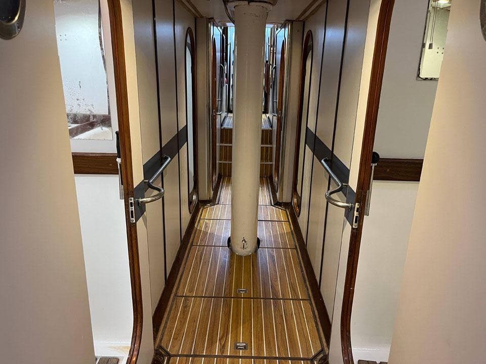 Devonport Challenge 67 yacht interior corridor, 1992 model, featuring wooden flooring and elegant design.