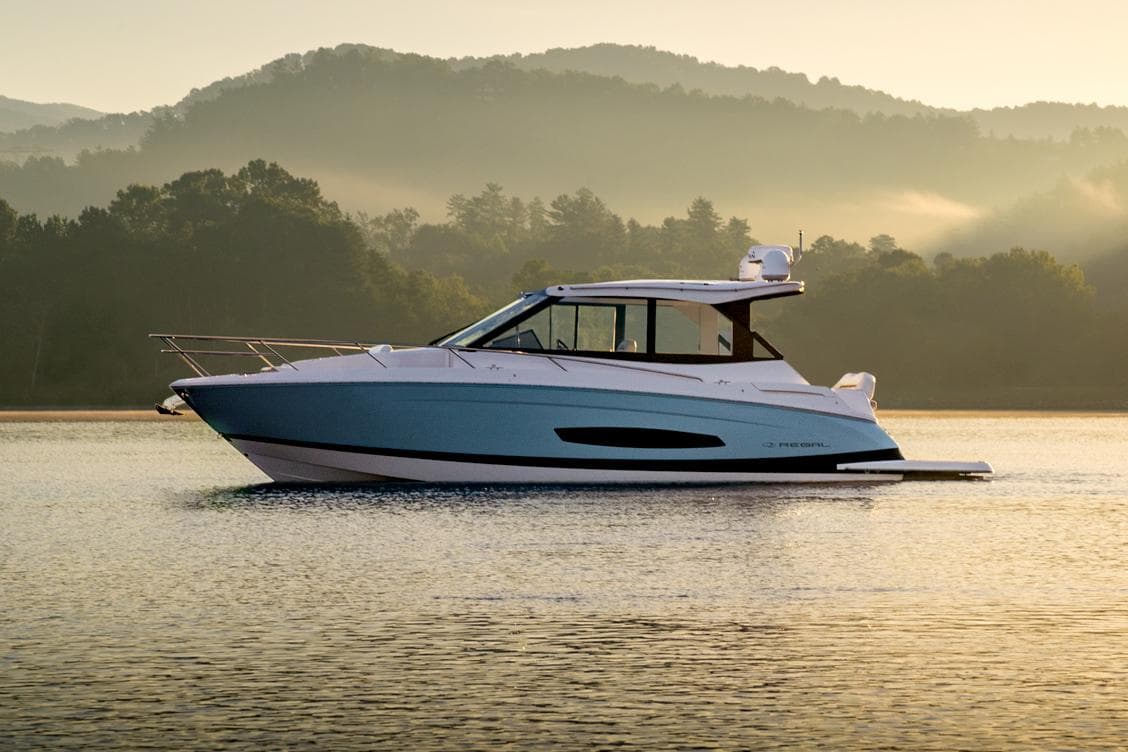 Manufacturer Provided Image: 2026 Regal 36 Grande Coupe yacht on serene lake with misty mountains in background.