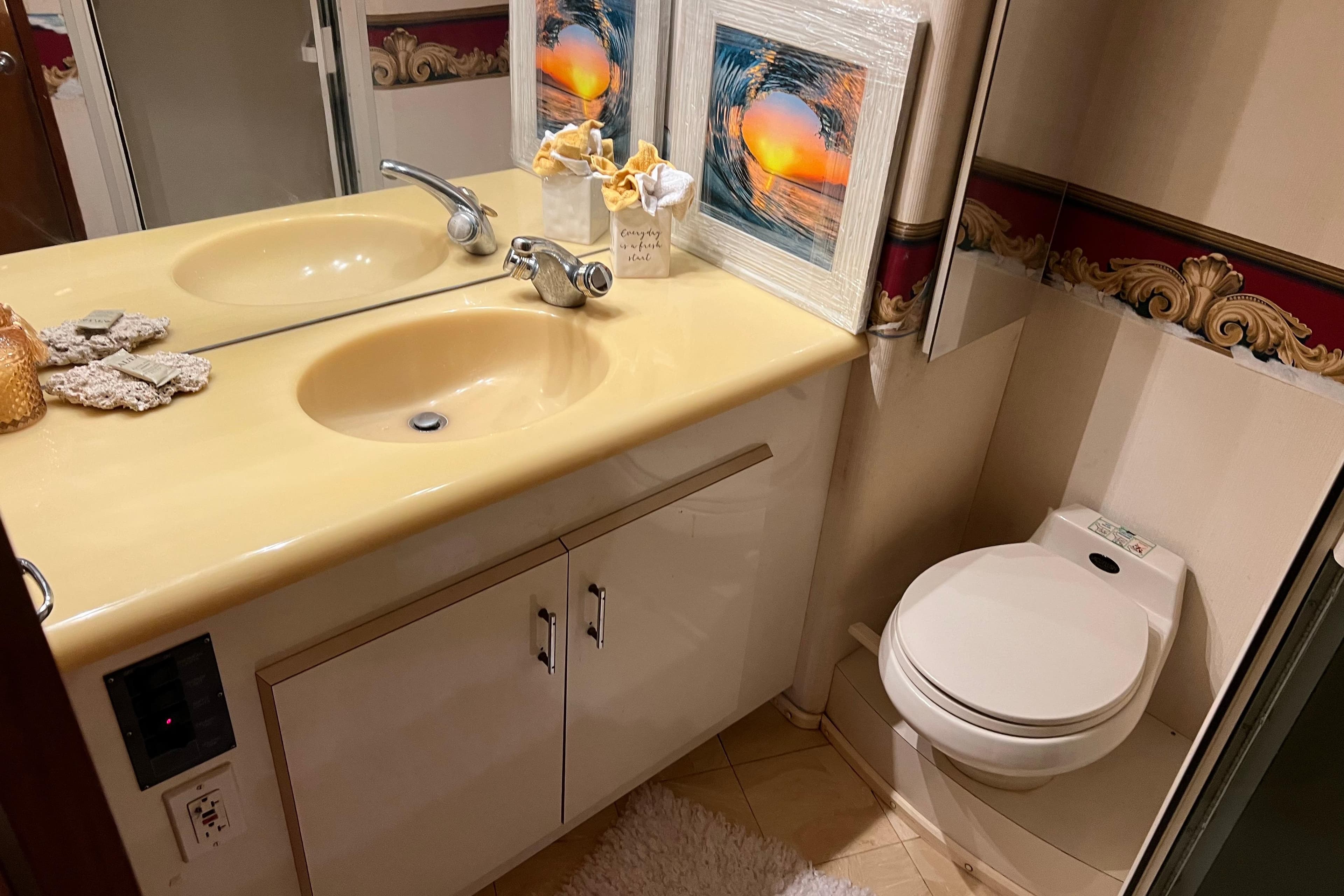 Luxurious bathroom in 1999 Viking 60 CPMY yacht with dual sinks and elegant decor.