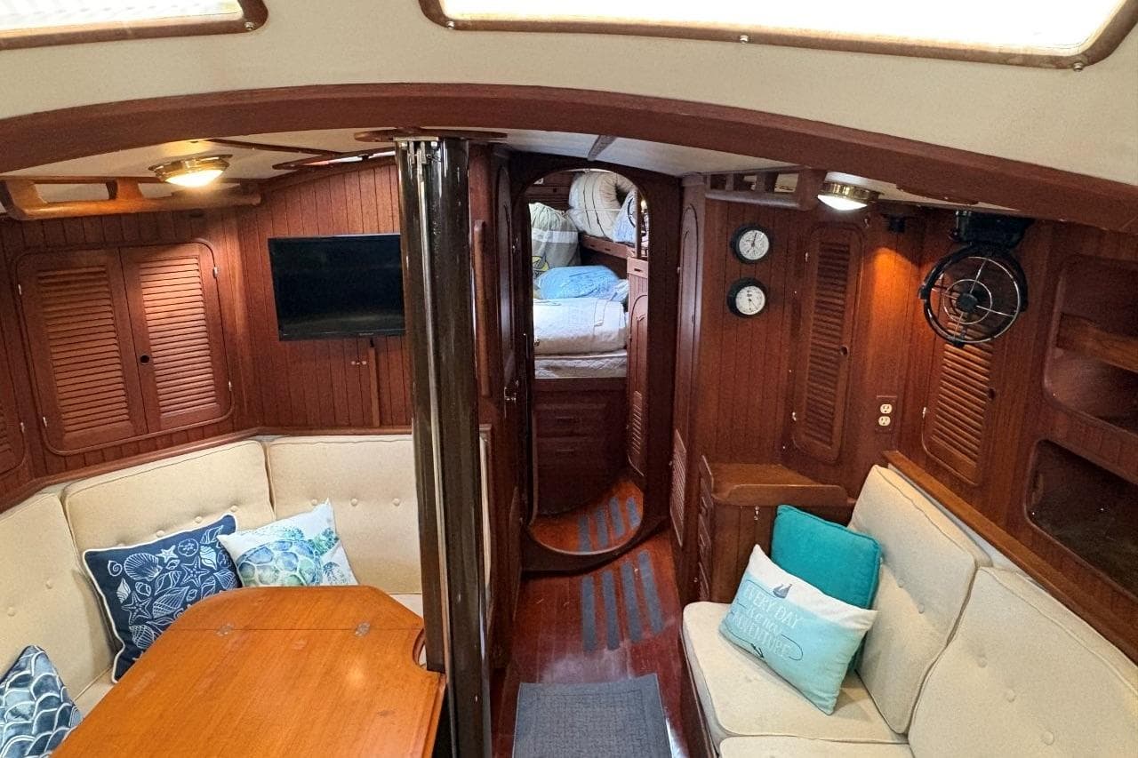 Interior of 1981 Norseman 447 yacht with cozy seating and wooden finishes.