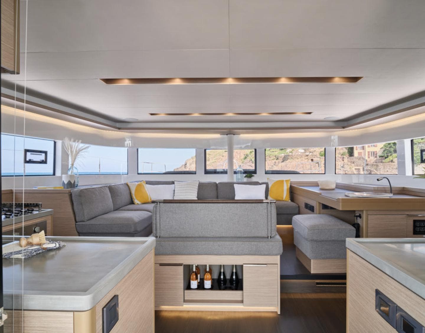 Luxurious interior of 2025 Lagoon 51 yacht with modern furnishings and panoramic windows.