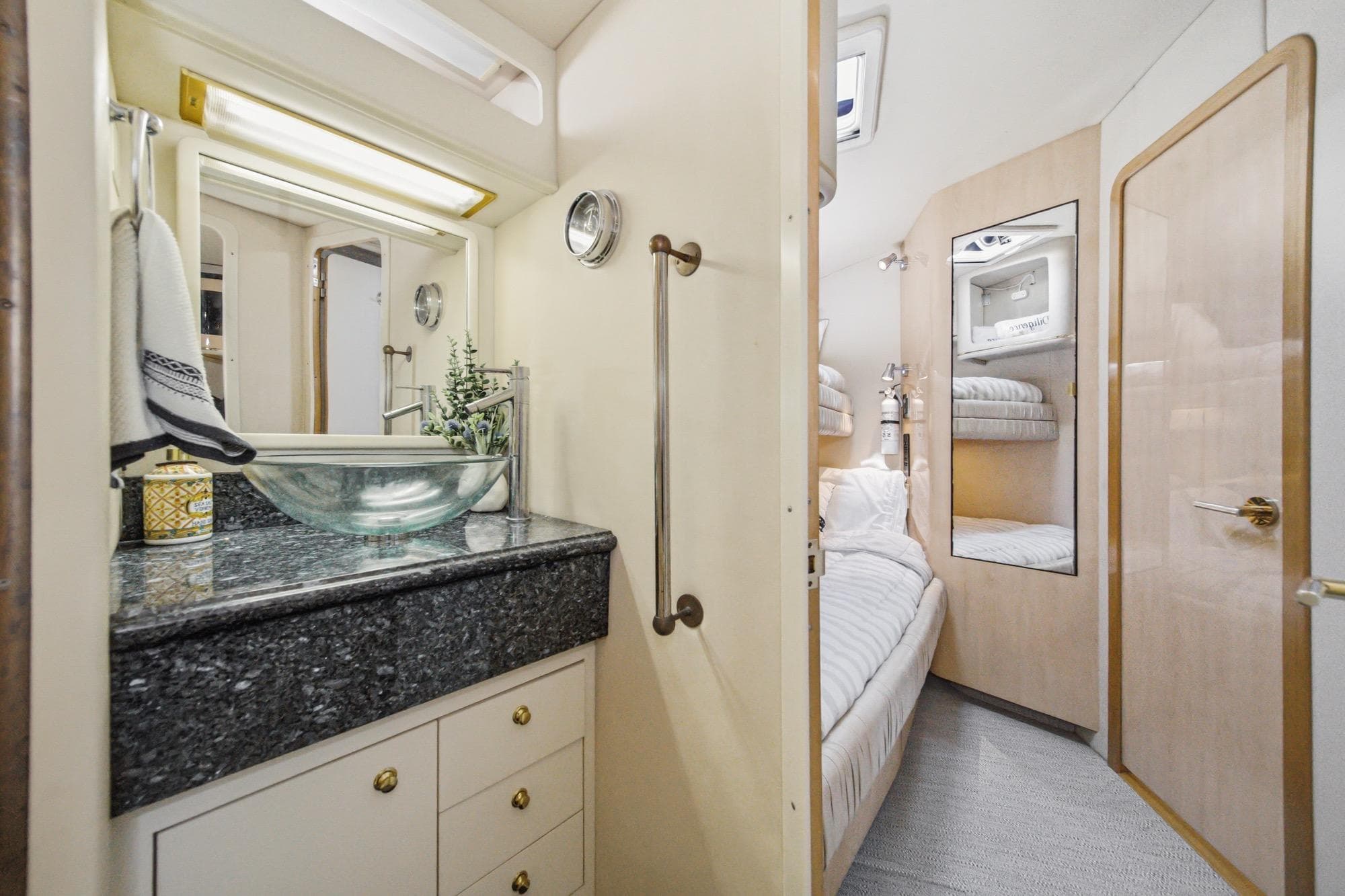 Luxurious 1999 Sea Ray 500 Sundancer yacht interior with elegant bathroom and cozy bedroom.