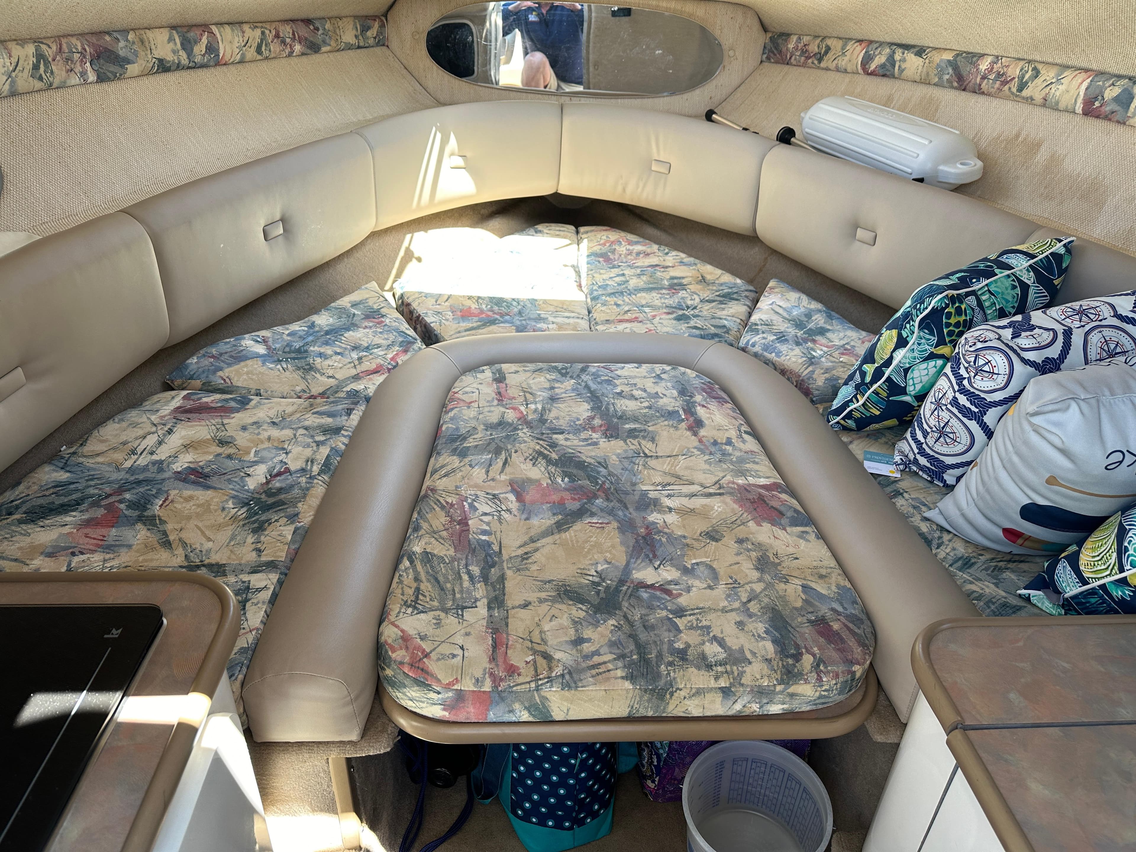 1998 Chaparral 2335 SS boat interior with cushioned seating and patterned upholstery.