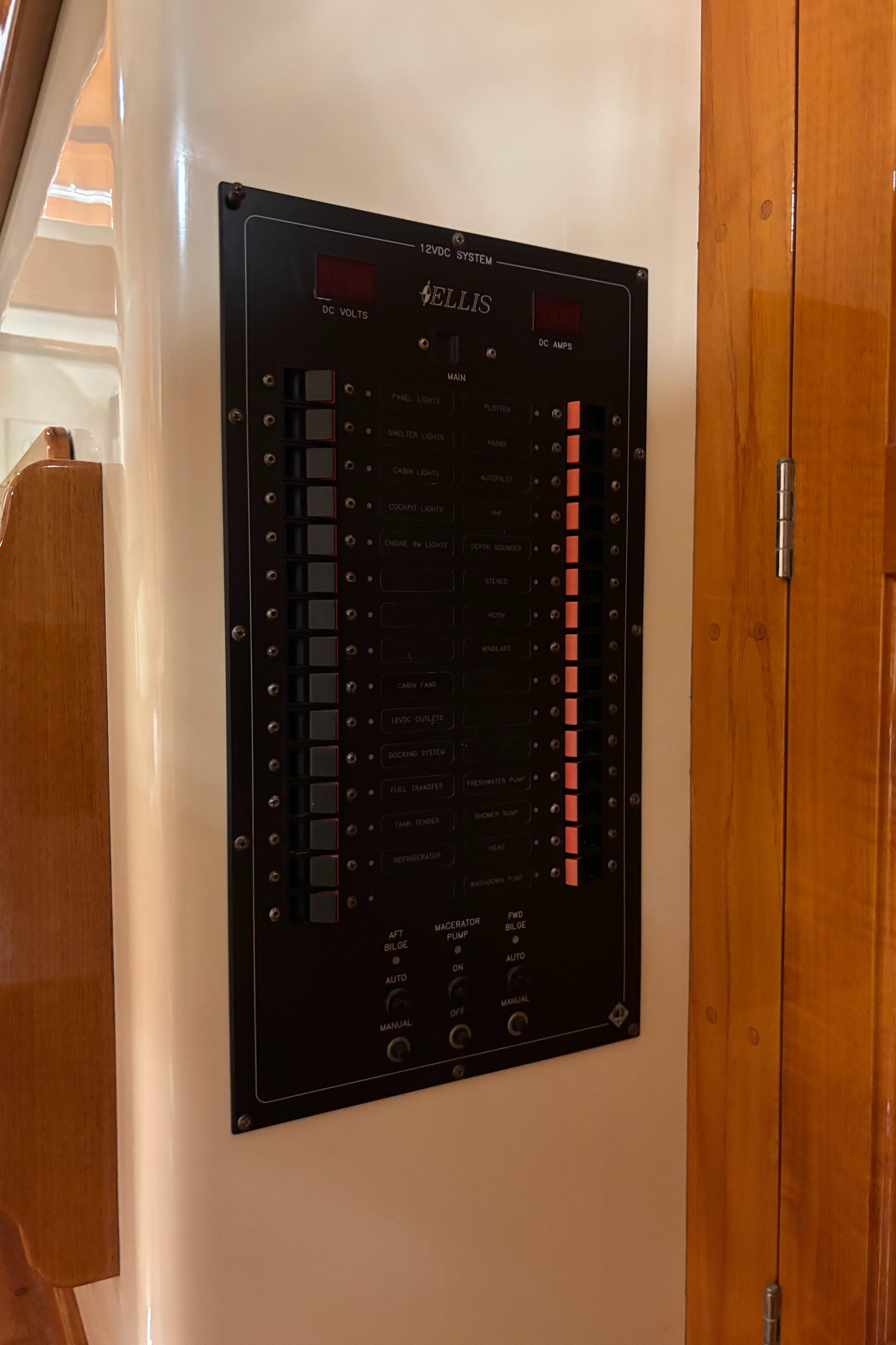 Electrical panel on a 2006 Ellis Express boat, mounted on a wooden wall.