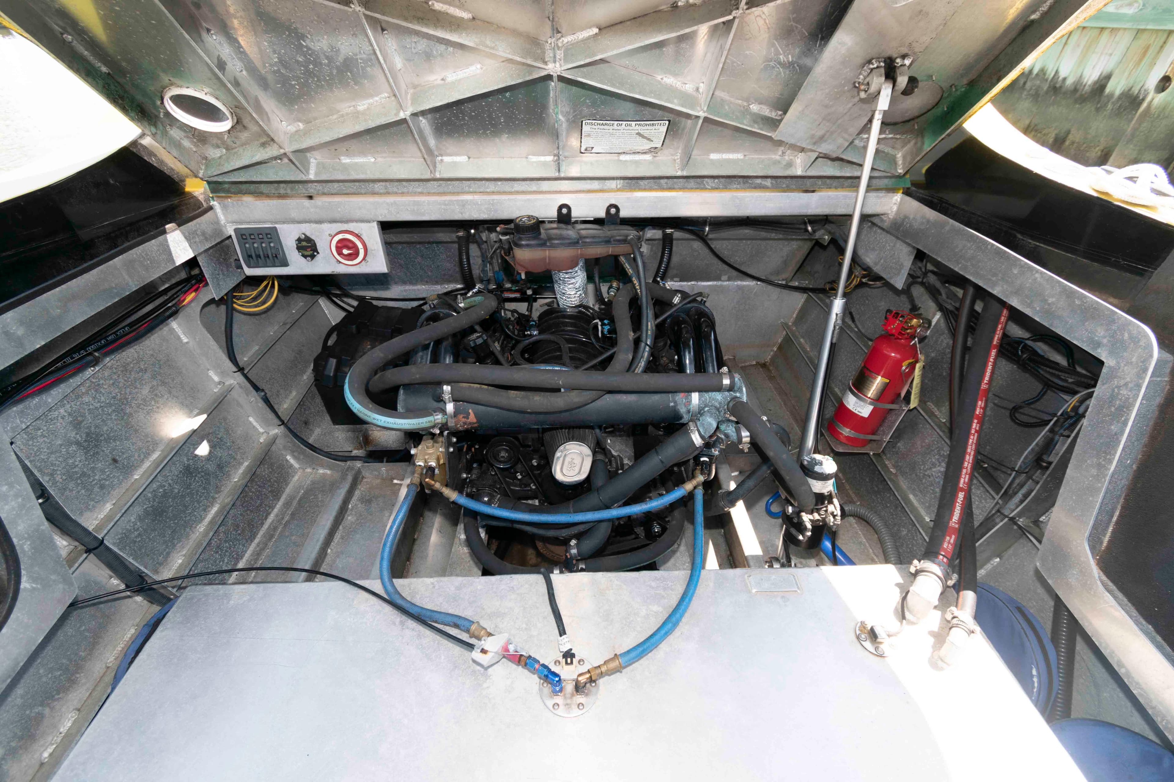 Engine compartment of a 2014 Custom Smokey Mountain Jet Boat with visible fire extinguisher.