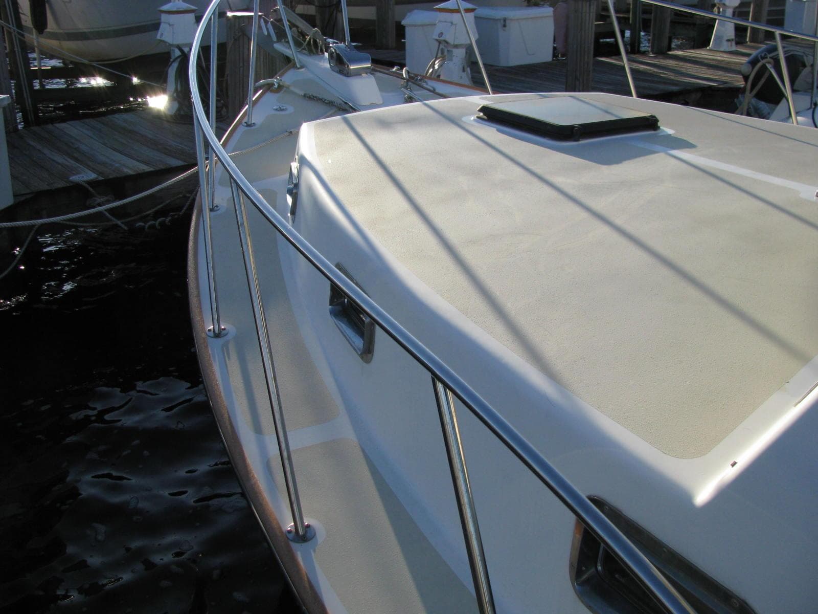 1998 Duffy 35 Downeast Cruiser boat deck with railing, docked at marina.