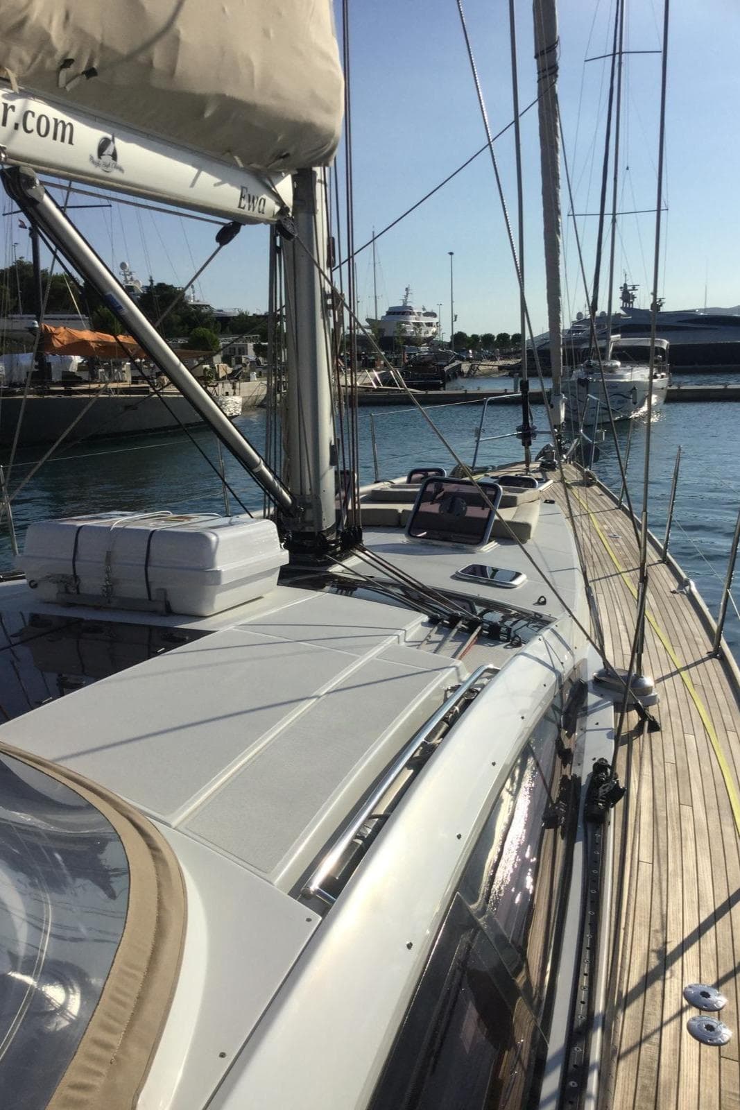 2015 Jeanneau 57 yacht docked in marina, showcasing sleek deck and rigging.