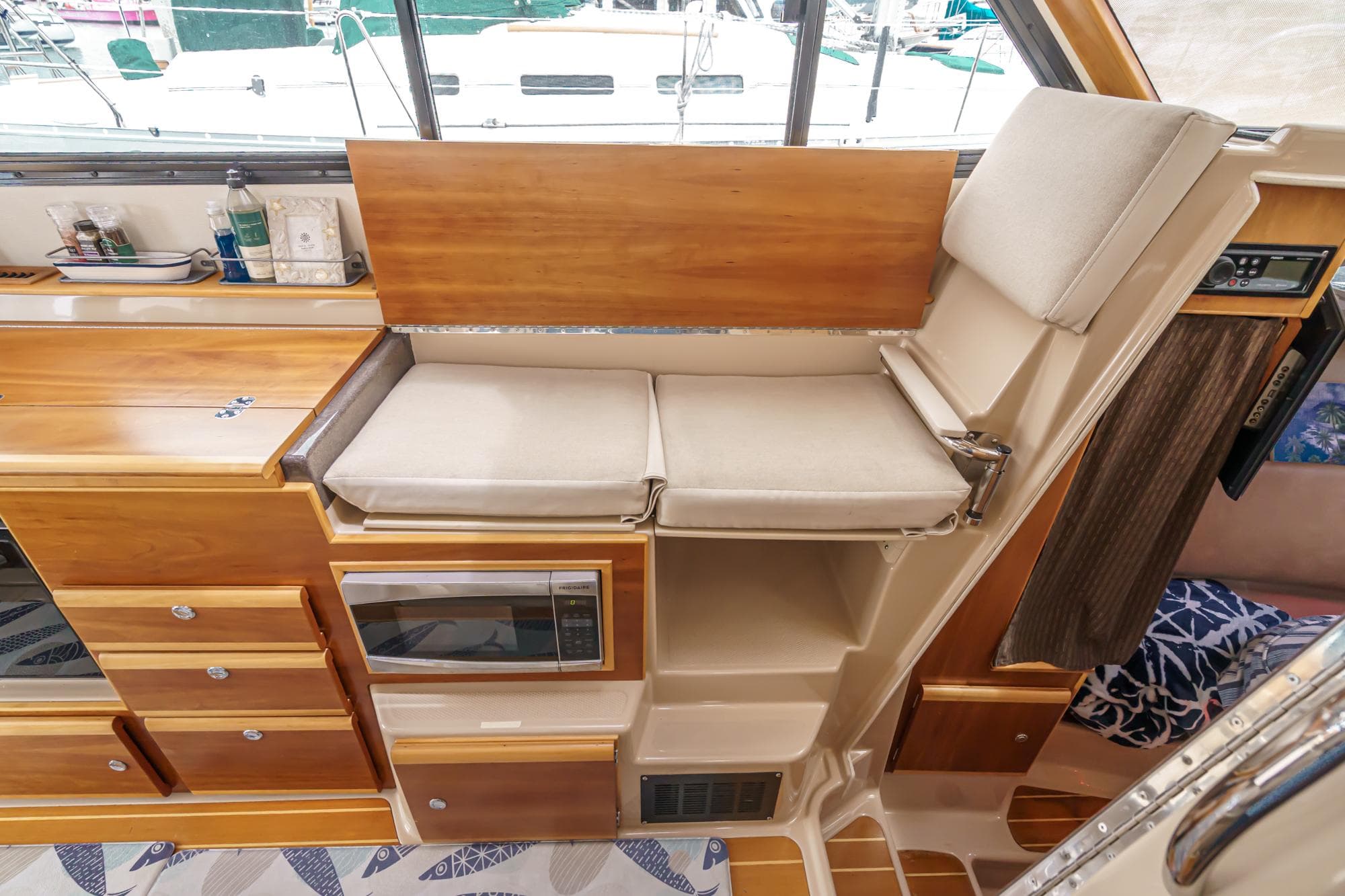 Interior of 2014 Cutwater C-30 SC LE boat with wooden cabinetry and cushioned seating.