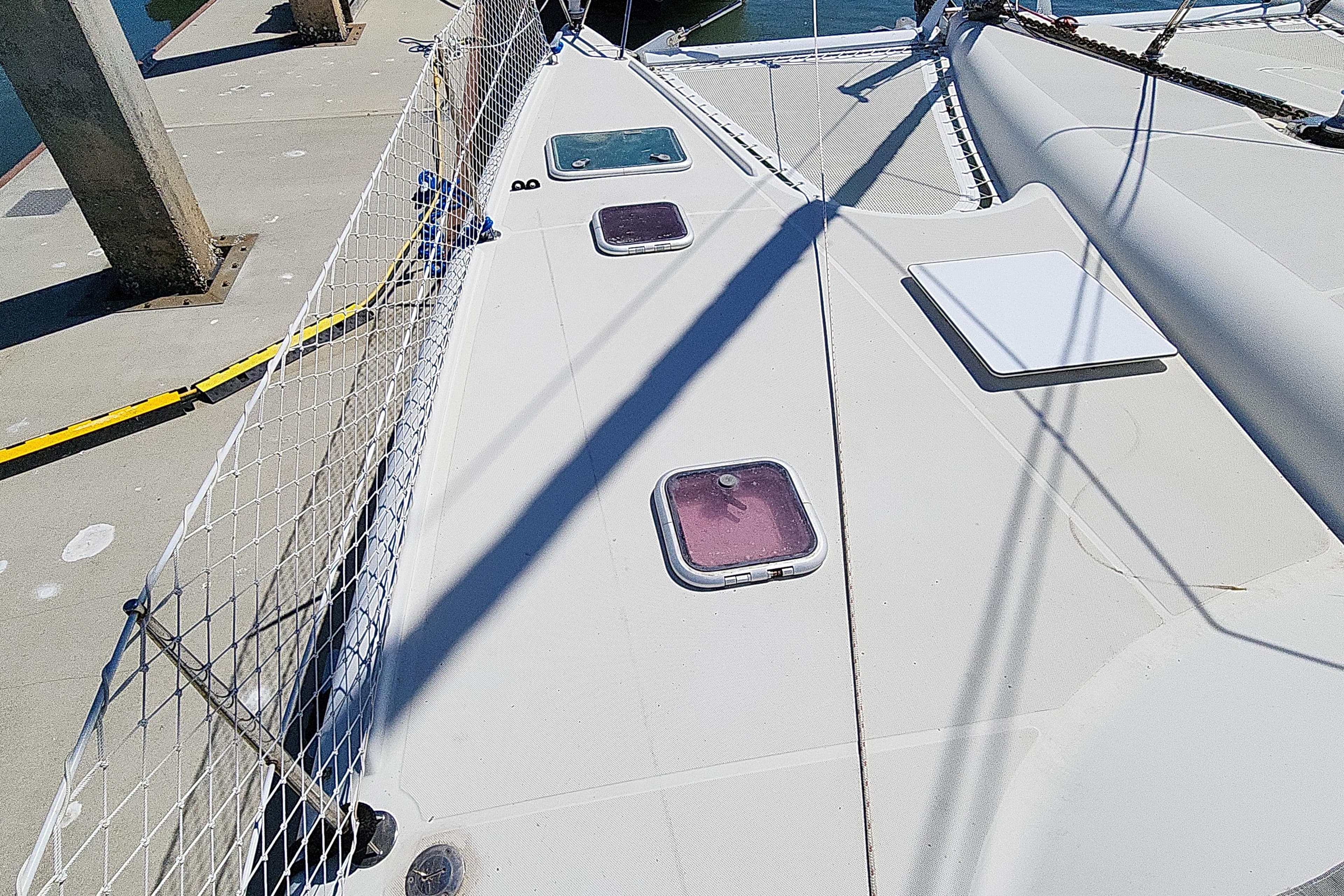 Deck of 2001 Privilege 435 catamaran with hatches and safety netting.