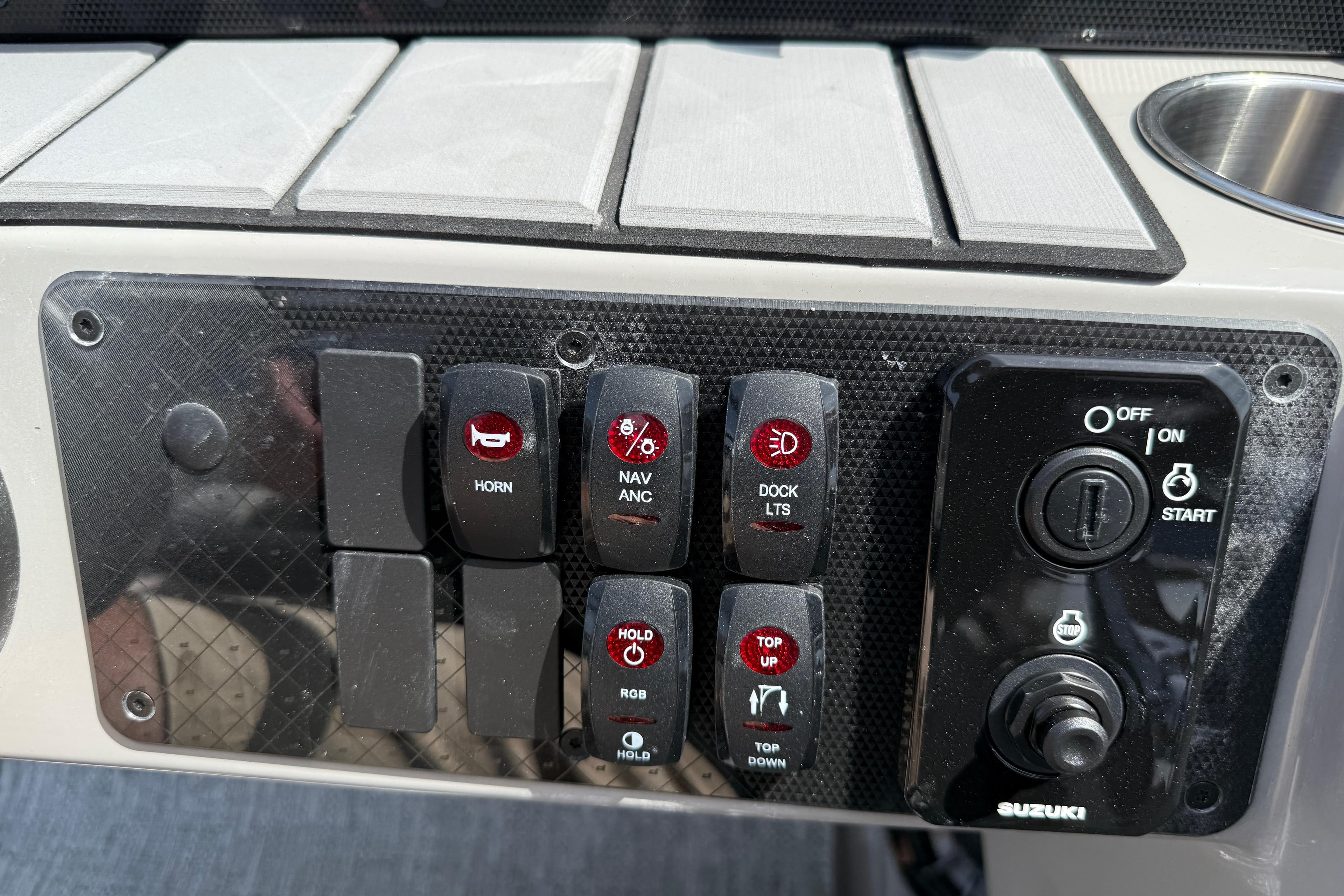 Control panel of 2026 Premier 230 SunSation RF boat with various switches and ignition.