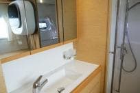 Modern bathroom interior of 2018 Lagoon 400 S2 yacht with sink and shower.